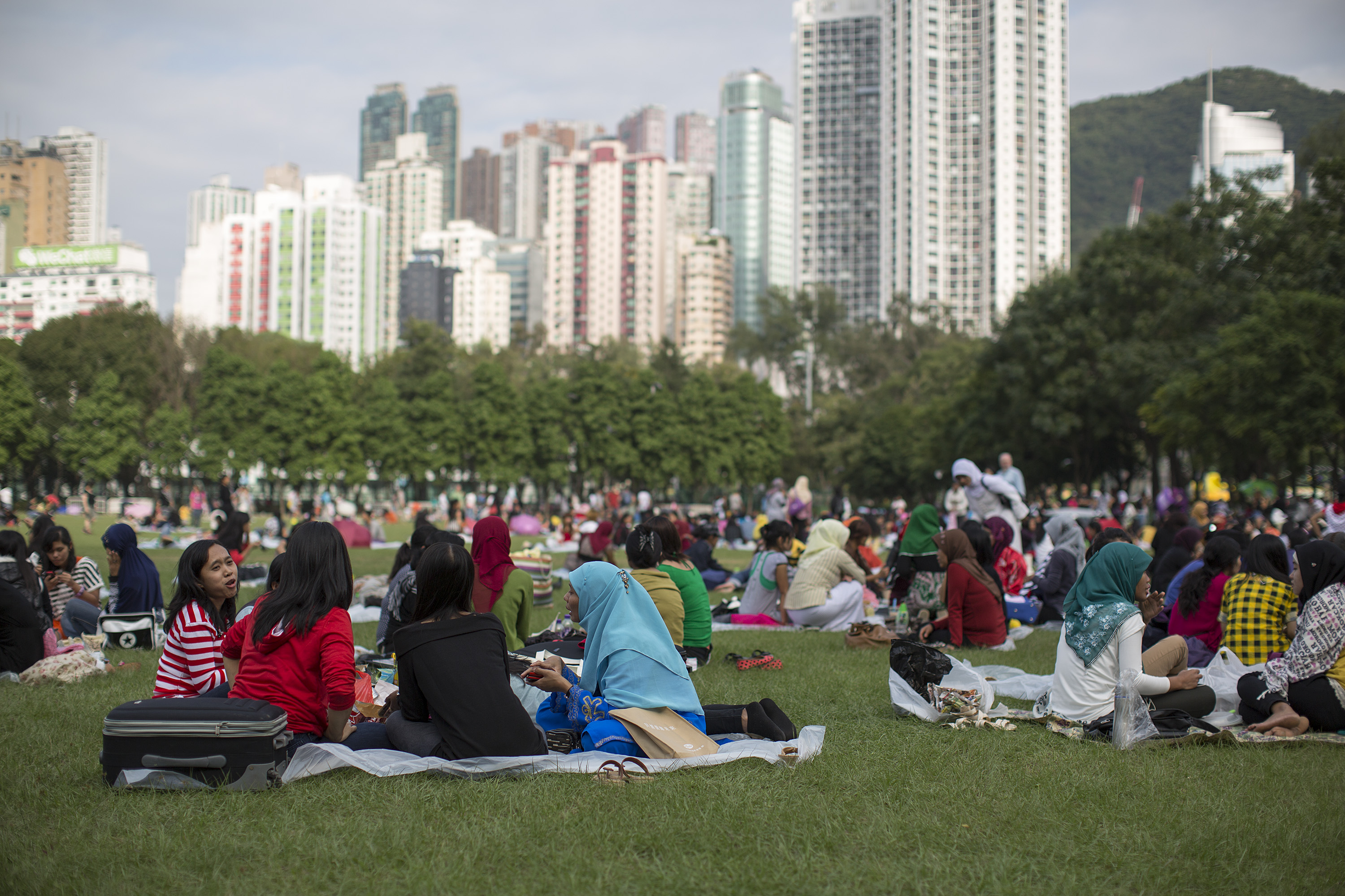 Migrant workers sit in Victoria Park on their day off in Hong Kong on Nov. 11, 2012 (Jerome Favre—Bloomberg/Getty Images)