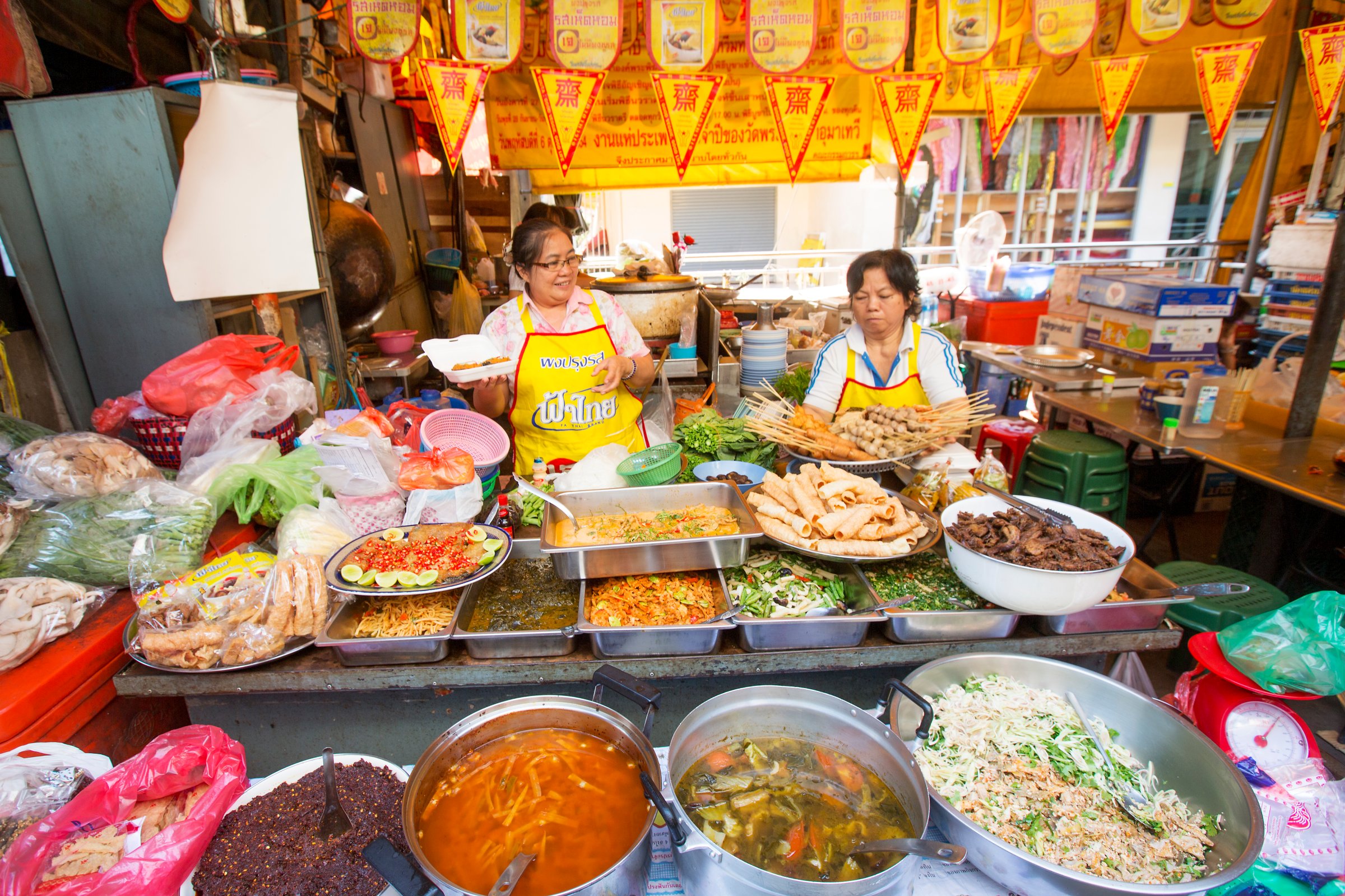 Two ladies serve Thai street food
