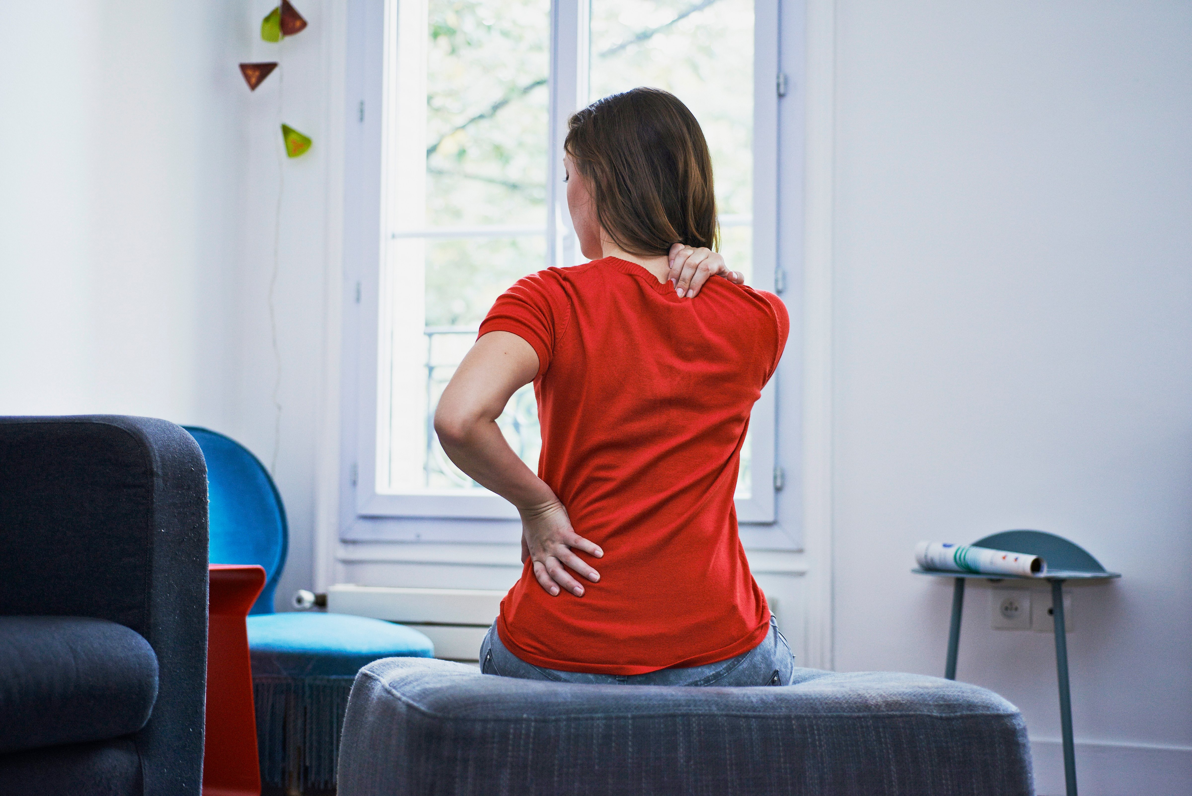 Woman suffering from back pain. France