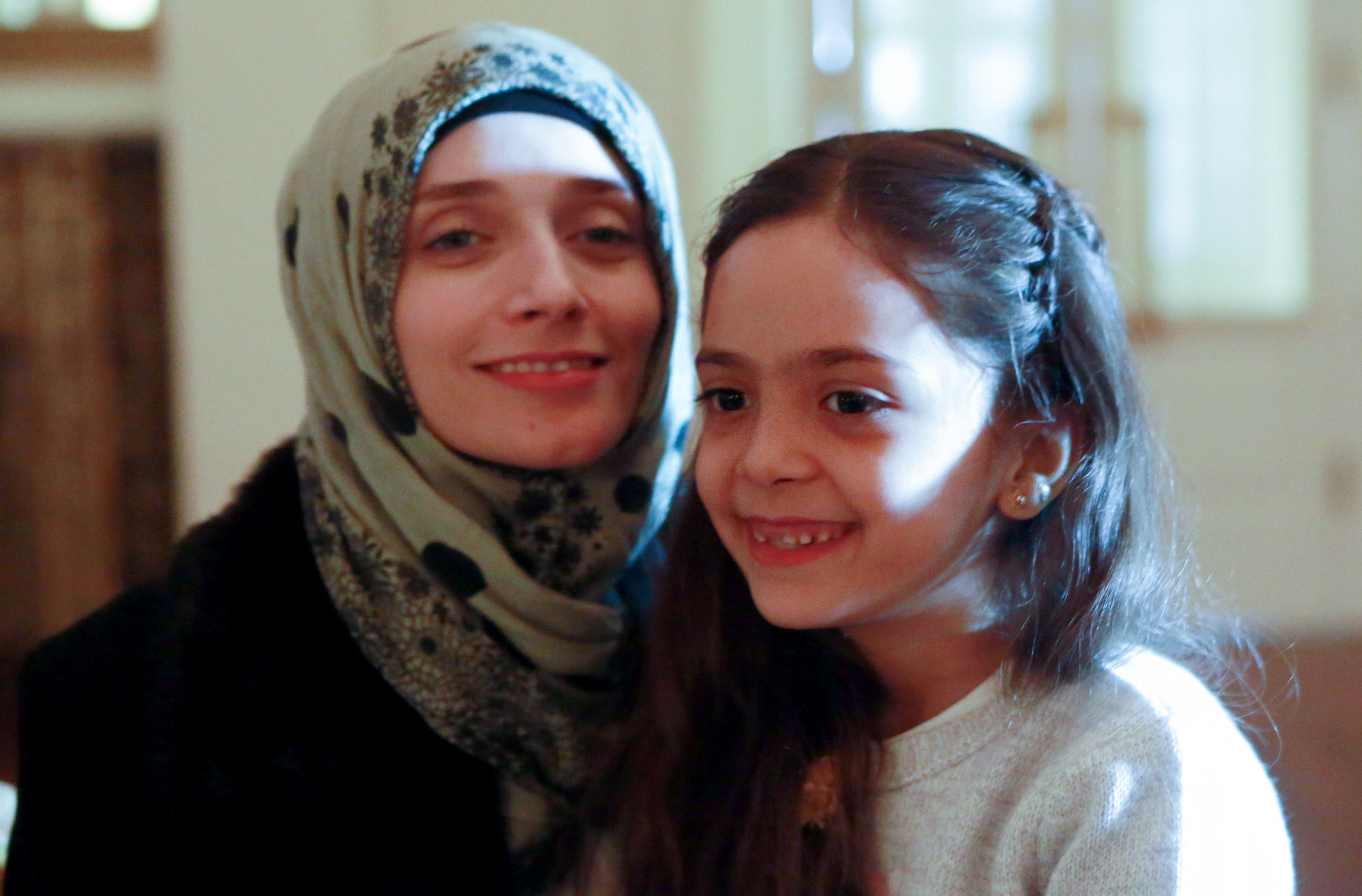 Syrian girl Bana al-Abed (R), known as Aleppo's tweeting girl, poses with her mother Fatemah during an interview in Ankara, Turkey, on December 22, 2016. (Adem Altan—AFP—Getty Images)