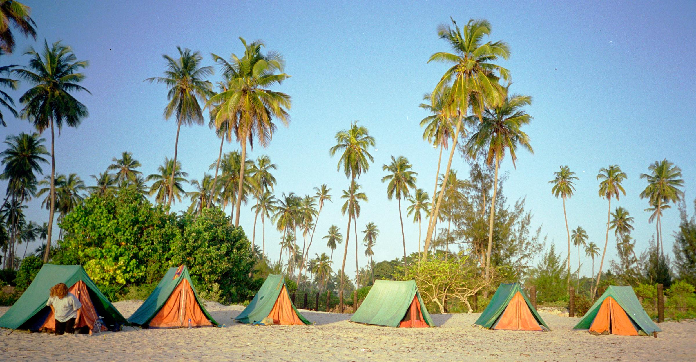 Africa, Tanzania, View Of Tourist Tents On The Beach During Adventure Travel Trip. They Are Fed Pizza And Hot Dogs, And Never Meet An African (Year 2000)