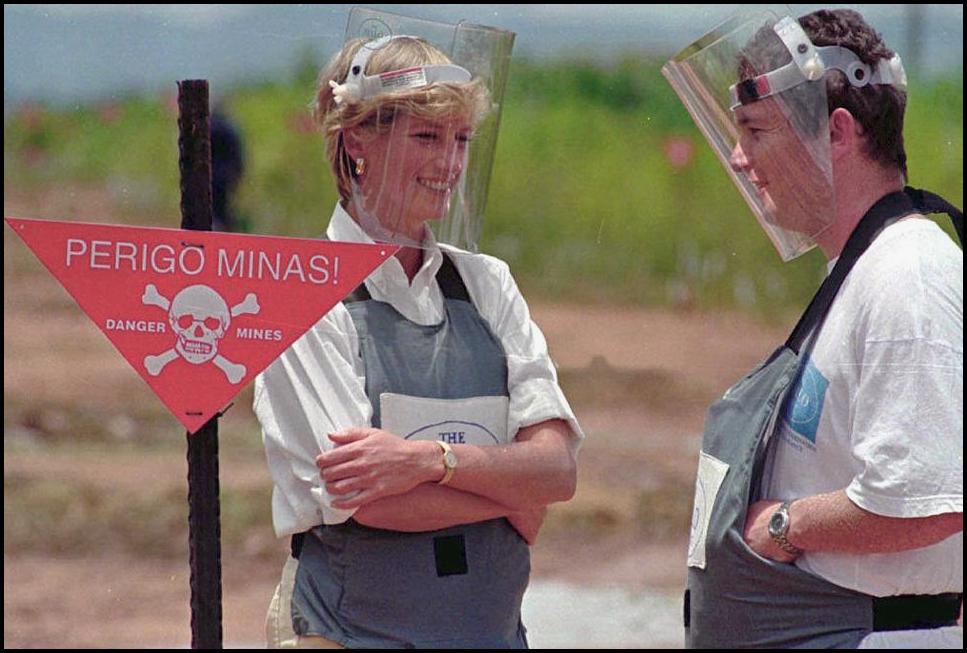 Britain's Princess Diana, is accompanied by a mine-clearing expert of the Halo Trust on 15 January 1997 in Huambo, Angola. (Antonio Cotrim—AFP—Getty Images)