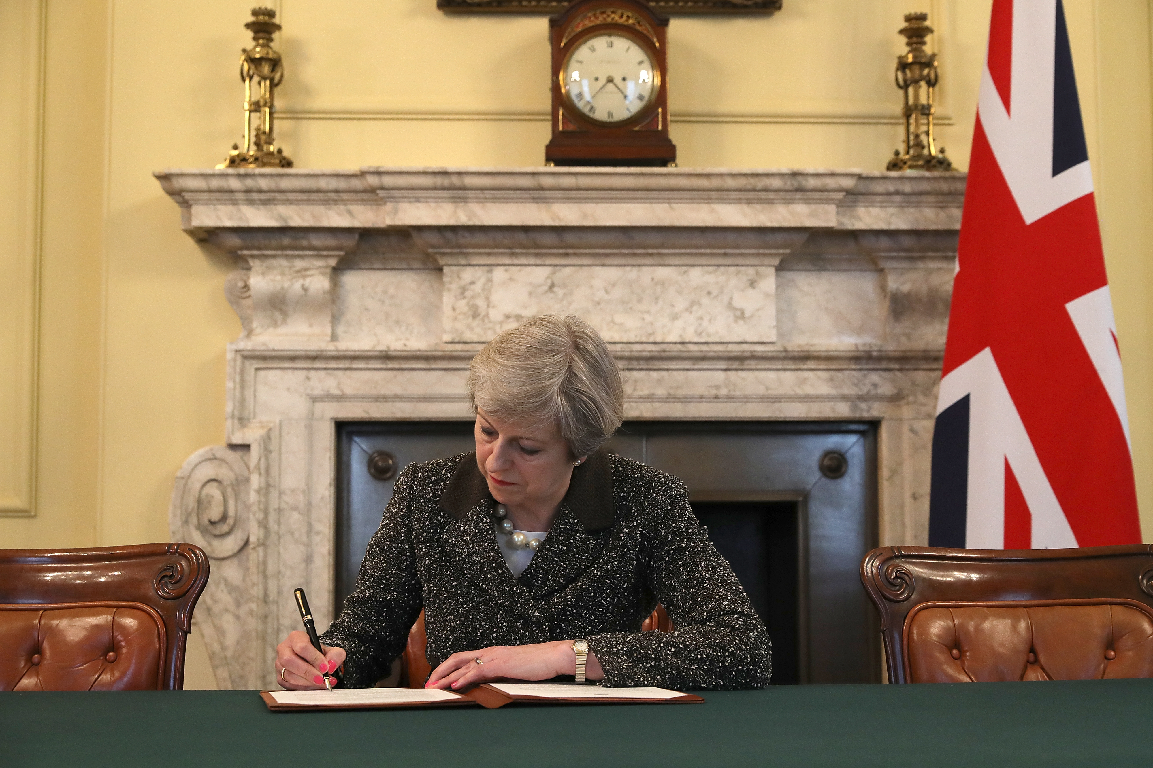 British Prime Minister Theresa May signs the official letter invoking Article 50 and the U.K.'s intention to leave the E.U. on March 28, 2017 in London. (Christopher Furlong—Getty Images)