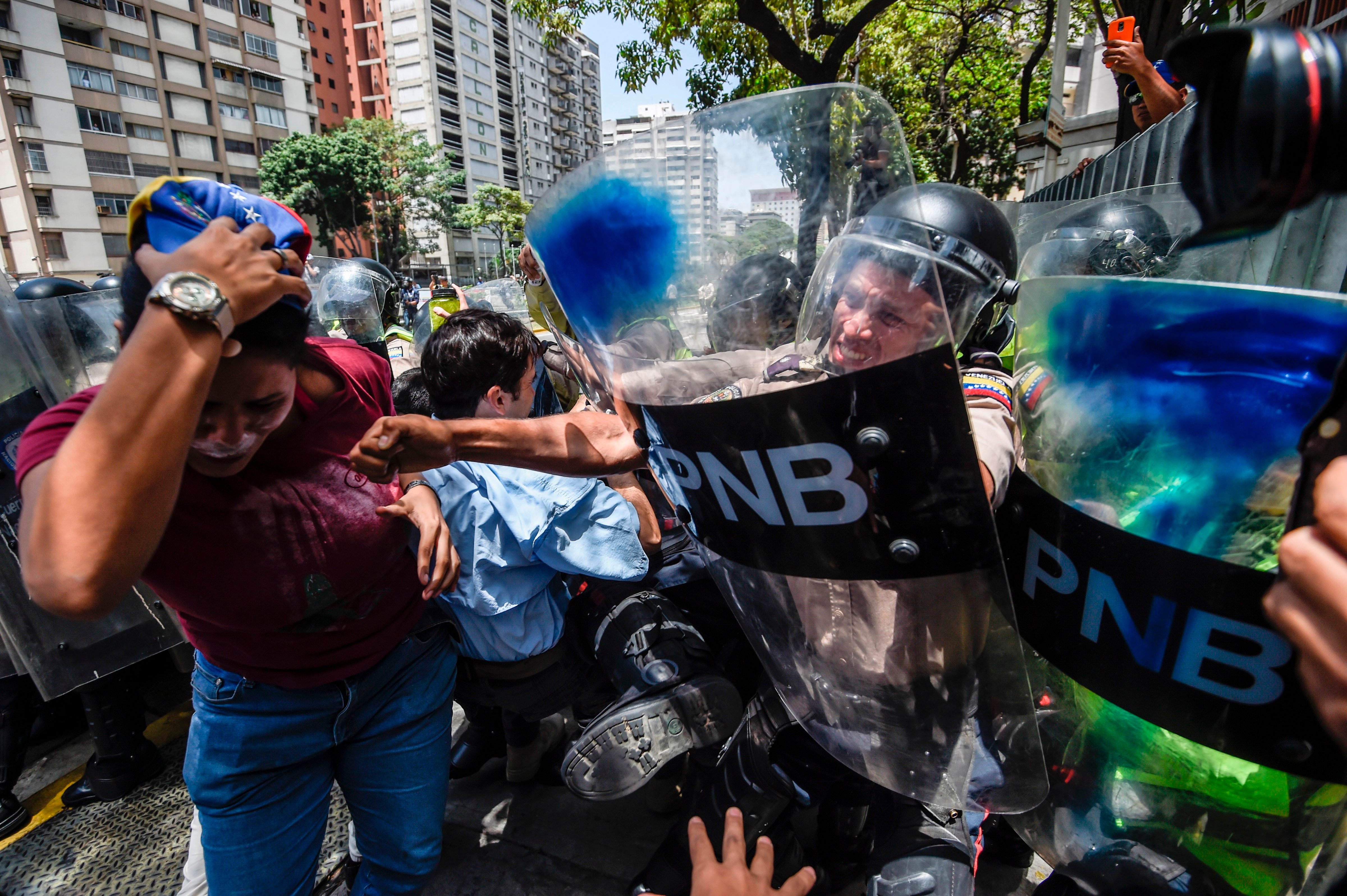 Venezuela's opposition activists scuffle with riot police during a protest against Nicolas Maduro's government in Caracas, Apr. 4, 2017. (Juan Barreto—AFP/Getty Images)