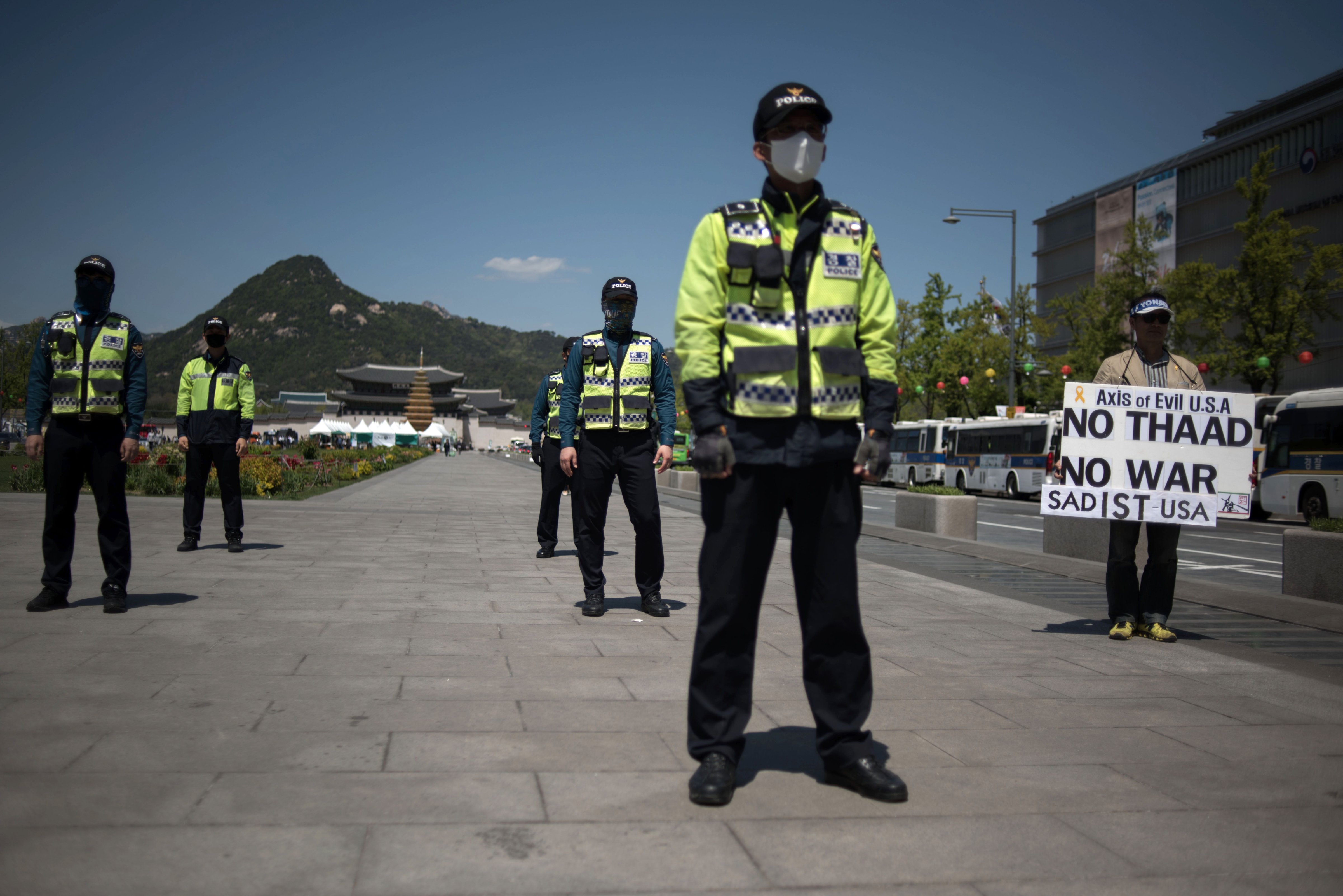 A protester holds a placard denouncing the THAAD anti-missile defence system in central Seoul on April 26, 2017. (Ed Jones—AFP/Getty Images)