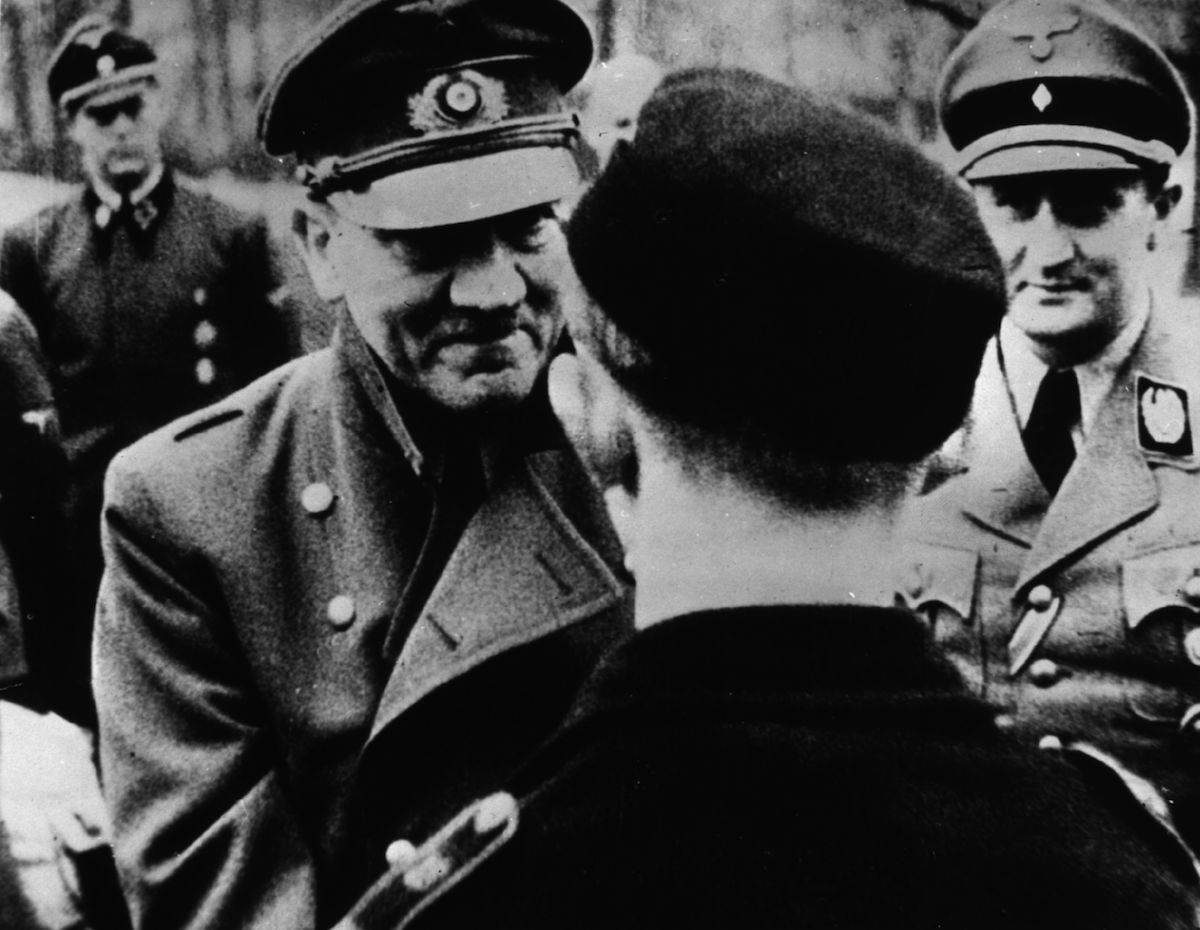 In his last official photo, Adolf Hitler (1889 - 1945) leaves the safety of his bunker to award decorations to members of Hitler Youth, in March of 1945. (Keystone Features / Getty Images)