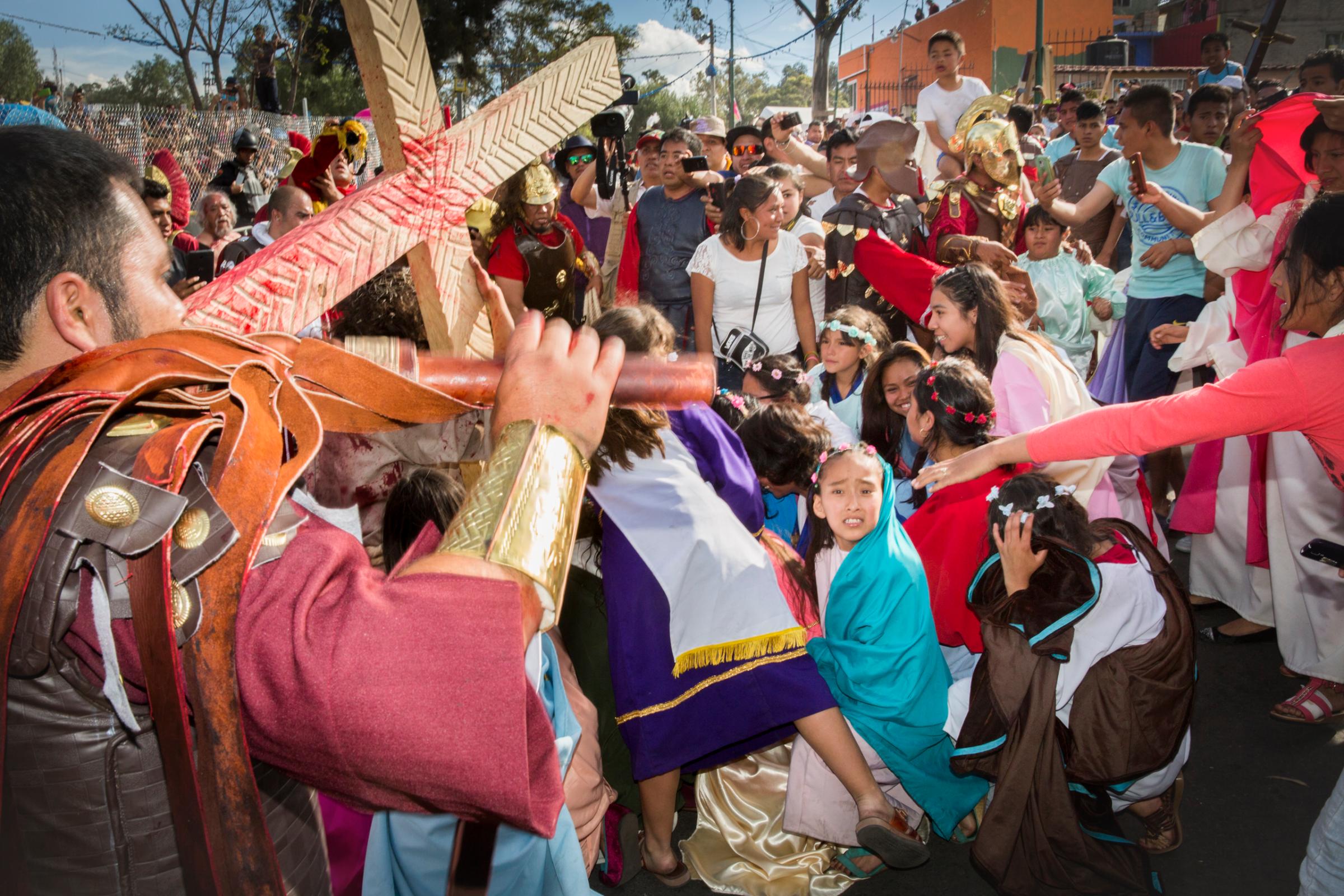 A child is scared by an actor playing the part of a Roman soldier during the reenactment of the crucifixion of Jesus during the Holy Week celebrations in Iztapalapa, Mexico.