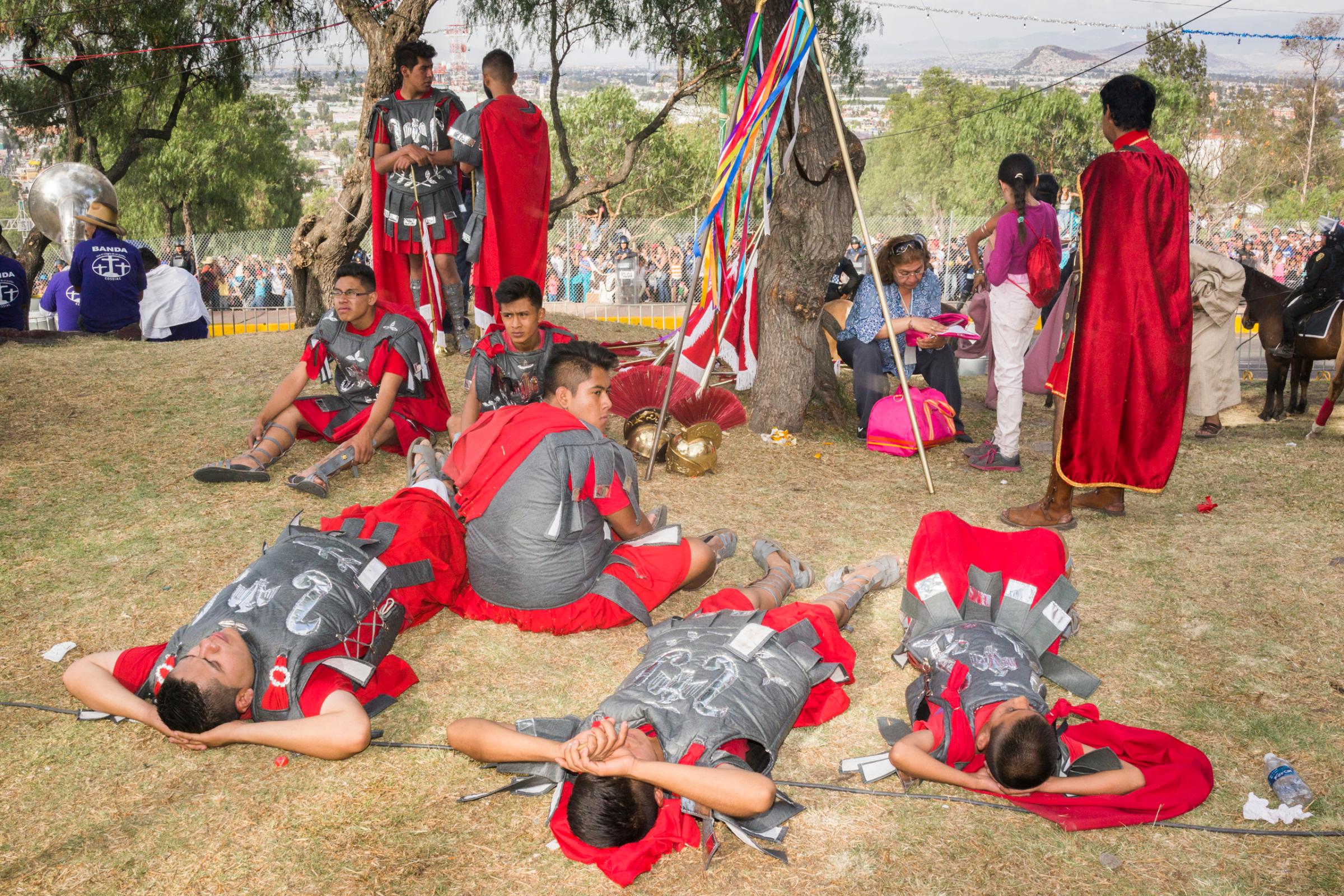 Actors playing the role of Roman soldiers rest after the reenactment of the Crucifixion of Jesus during Holy Week celebrations in Iztapalapa, Mexico.