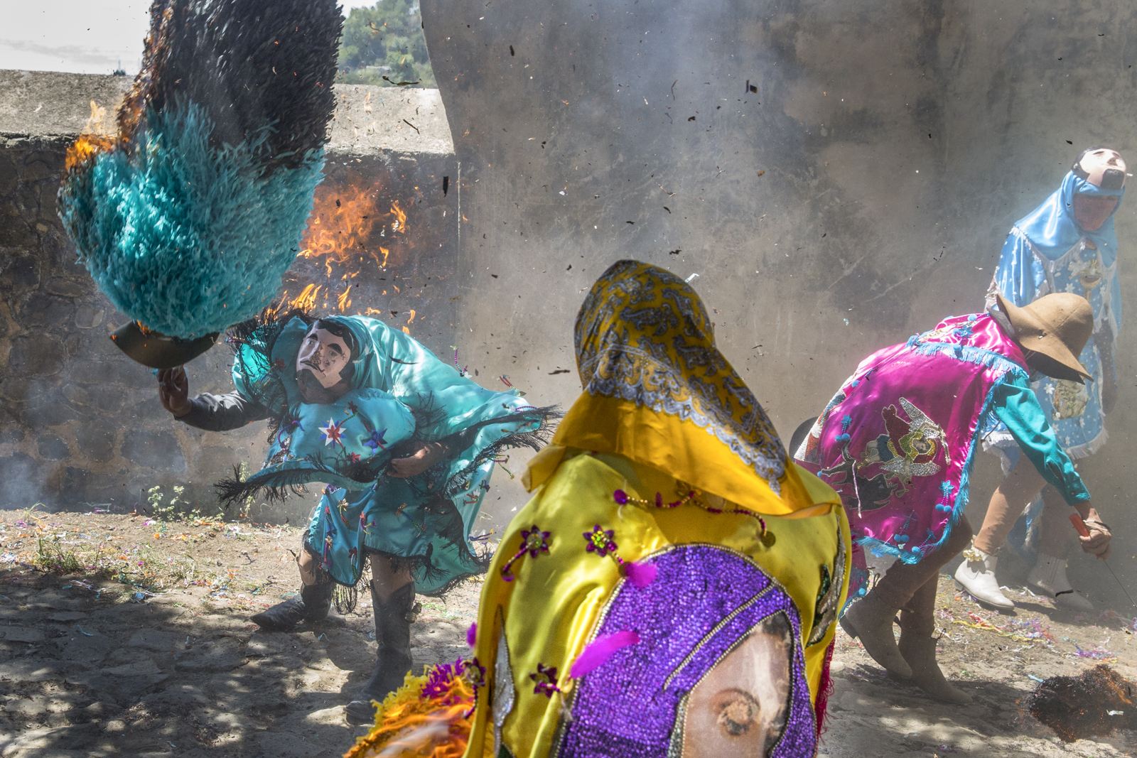 “Sayones" try to turn off their hats on fire during the Sunday ceremony that ends Holy Week in Tetela del Volcan, Morelos, Mexico. The Sayones, whose costumes are typical of the village, impersonate the Roman soldiers who killed Jesus. Their costumes are brightly colored with figures of saints, they hold machetes and wear a goat leather mask and big paper hats. After the mass that ends Holy Week on Sunday they run among the public attending the ceremony, and people throw lit matches at them to set their hats on fire, in sign of vengeance for their murderous act.