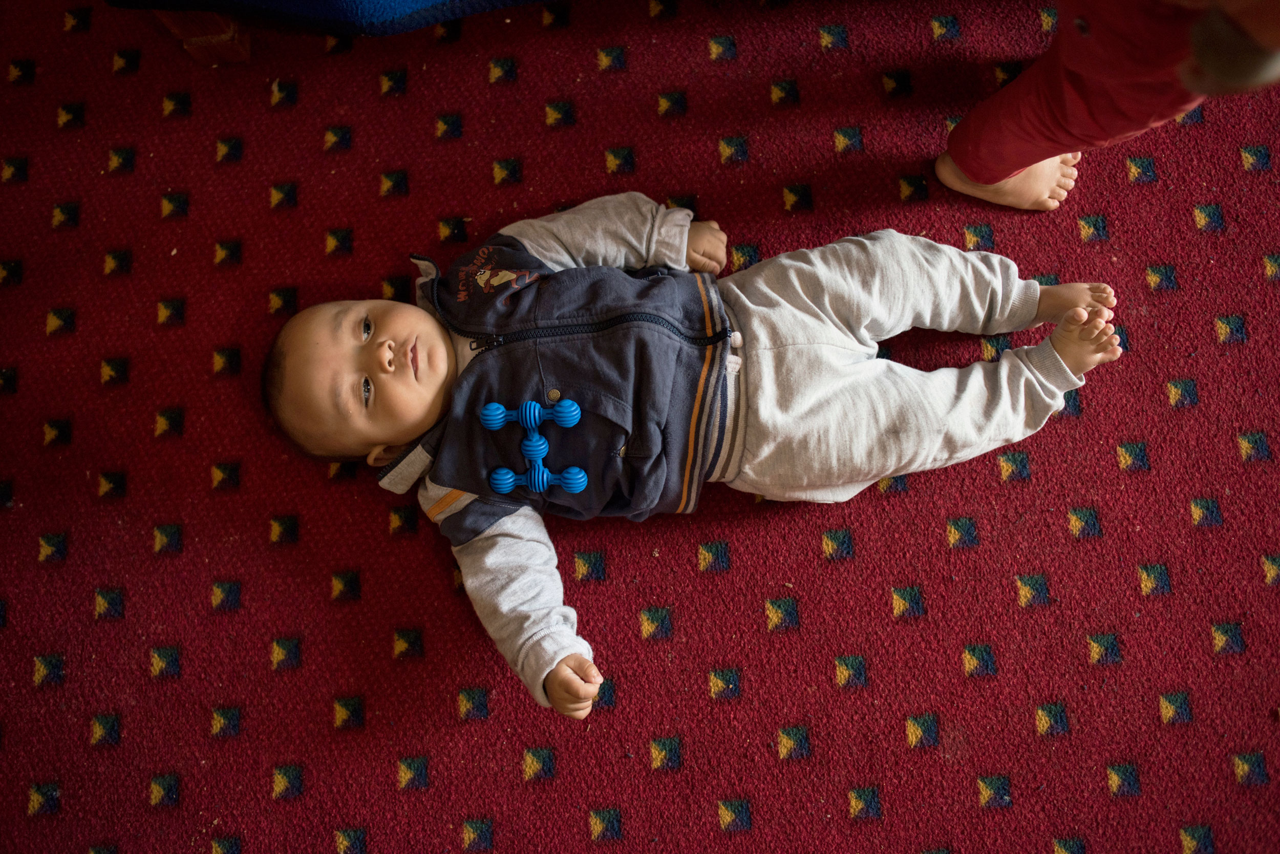 Faraj, who was born in a Greek refugee camp in October, rests after trying to learn to roll over (Lynsey Addario—Verbatim for TIME)