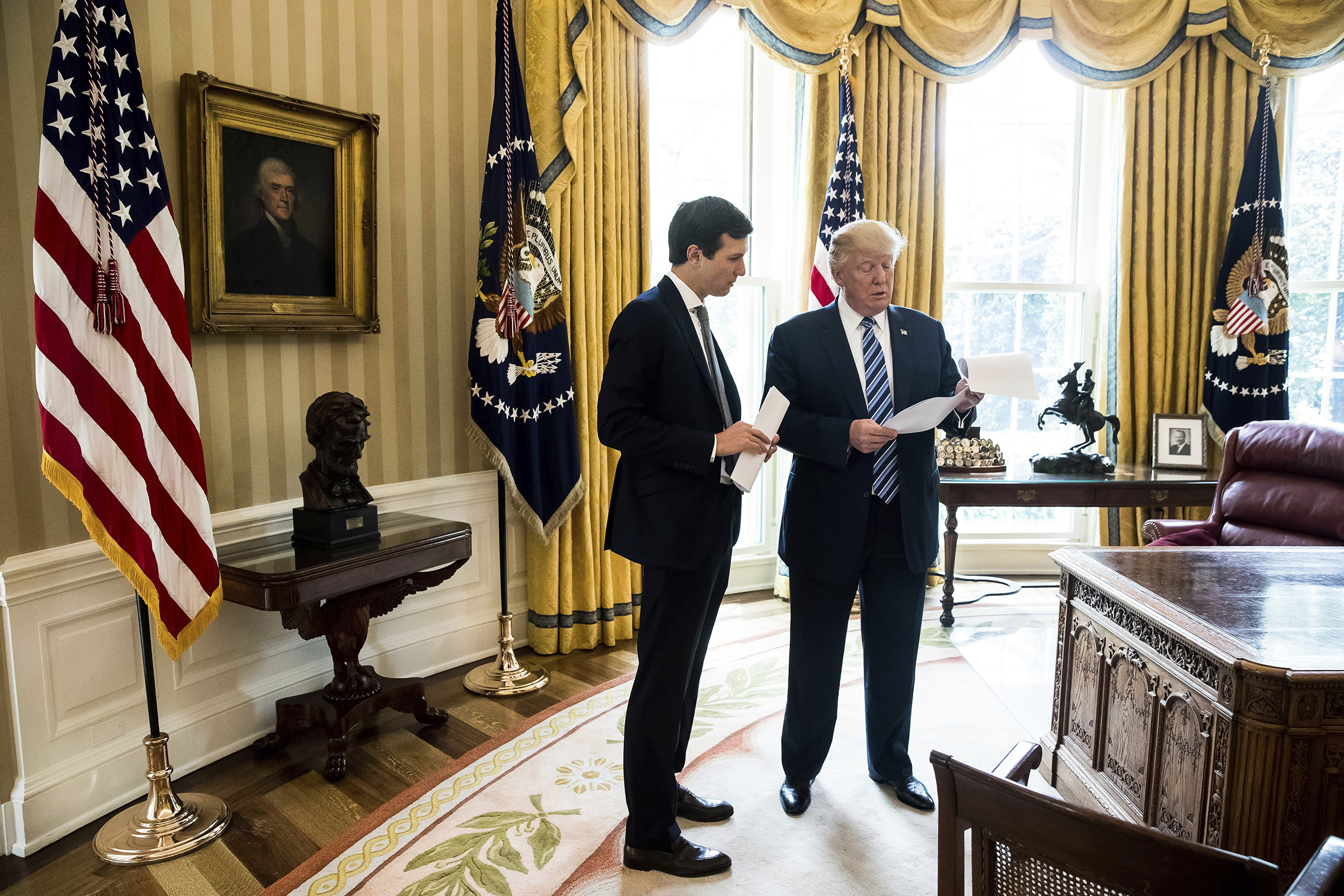 President Donald Trump speaks to his son- in-law White House Senior Adviser Jared Kushner, left, in the Oval Office in Washington,  April 21, 2017.