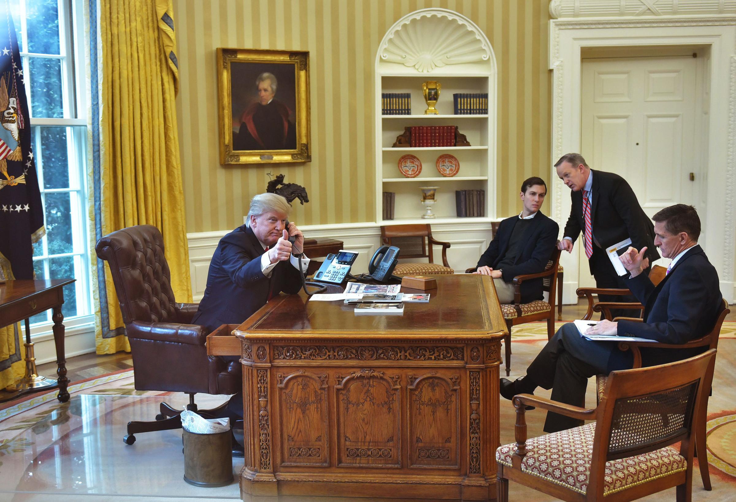 Jared Kushner (2L), Press Secretary Sean Spicer (2R), and Security Advisor Michael Flynn (R), with President Trump,as he speaks on the phone to King Salman of Saudi Arabia in the Oval Office on Jan. 29, 2017.