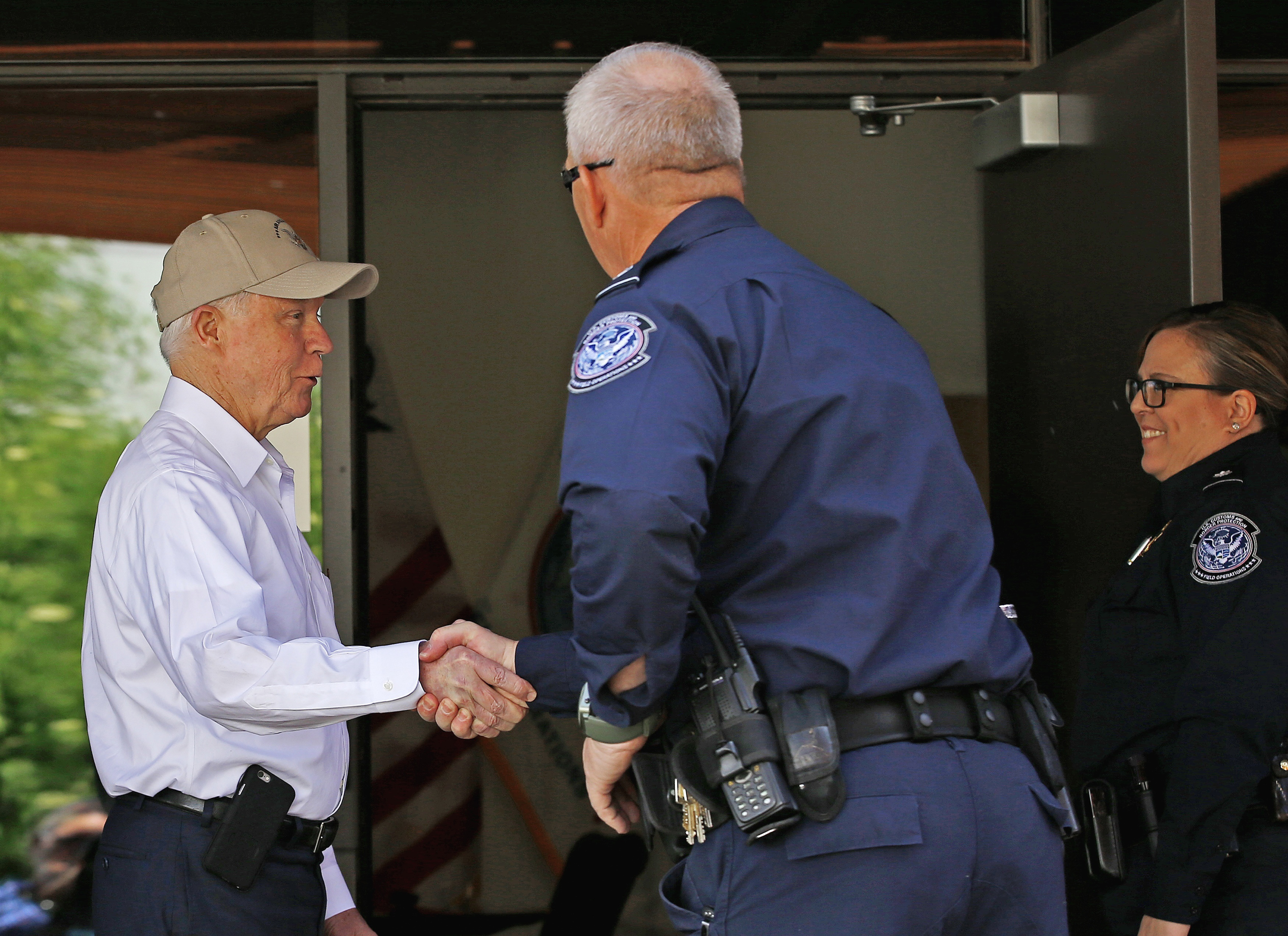 Attorney General Jeff Sessions, left, shakes hands with U.S. Customs and Border Protection officers as he tours the U.S.-Mexico border on April 11, 2017, in Nogales, Ariz. (Ross D. Franklin&mdash;AP)