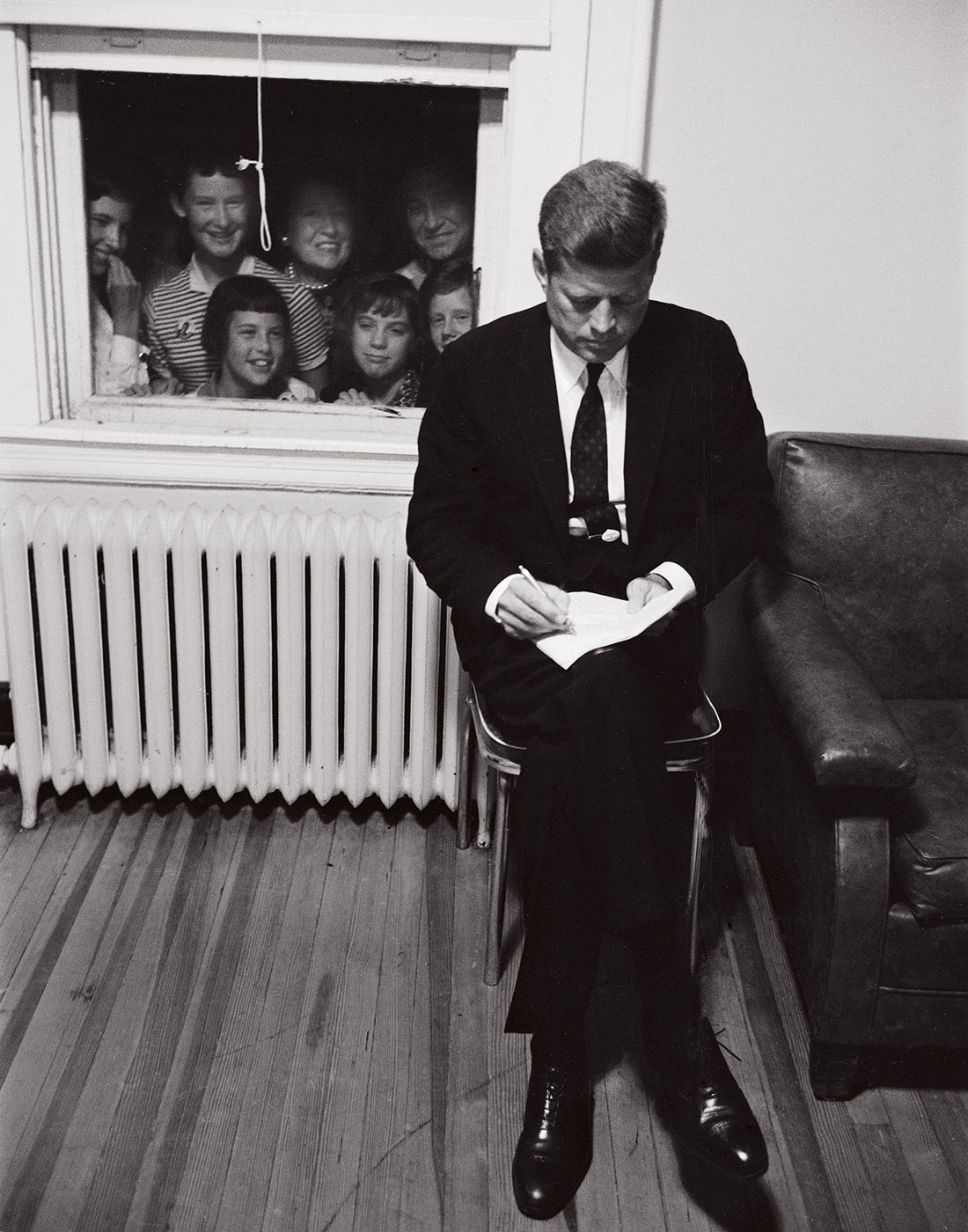Senator John F. Kennedy checking over a speech during the Presidential campaign.