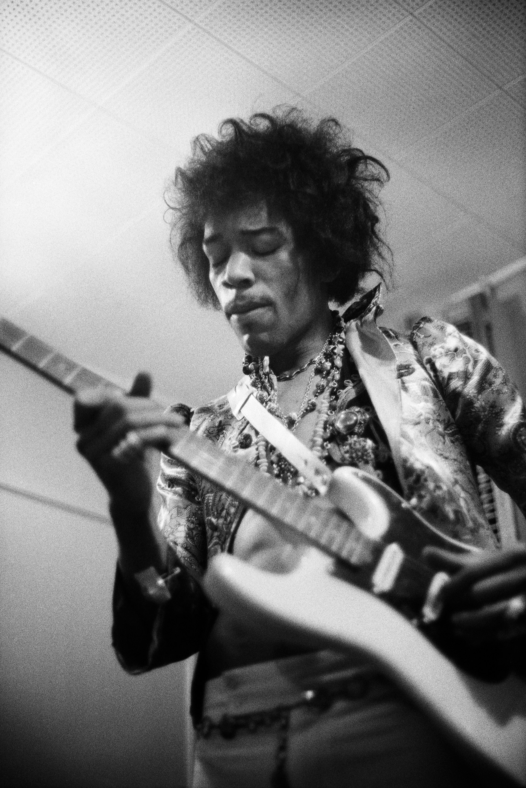 Jimi Hendrix plays his guitar in the dressing room before The Jimi Hendrix Experience performed at the Hollywood Bowl on Aug. 18, 1967.
