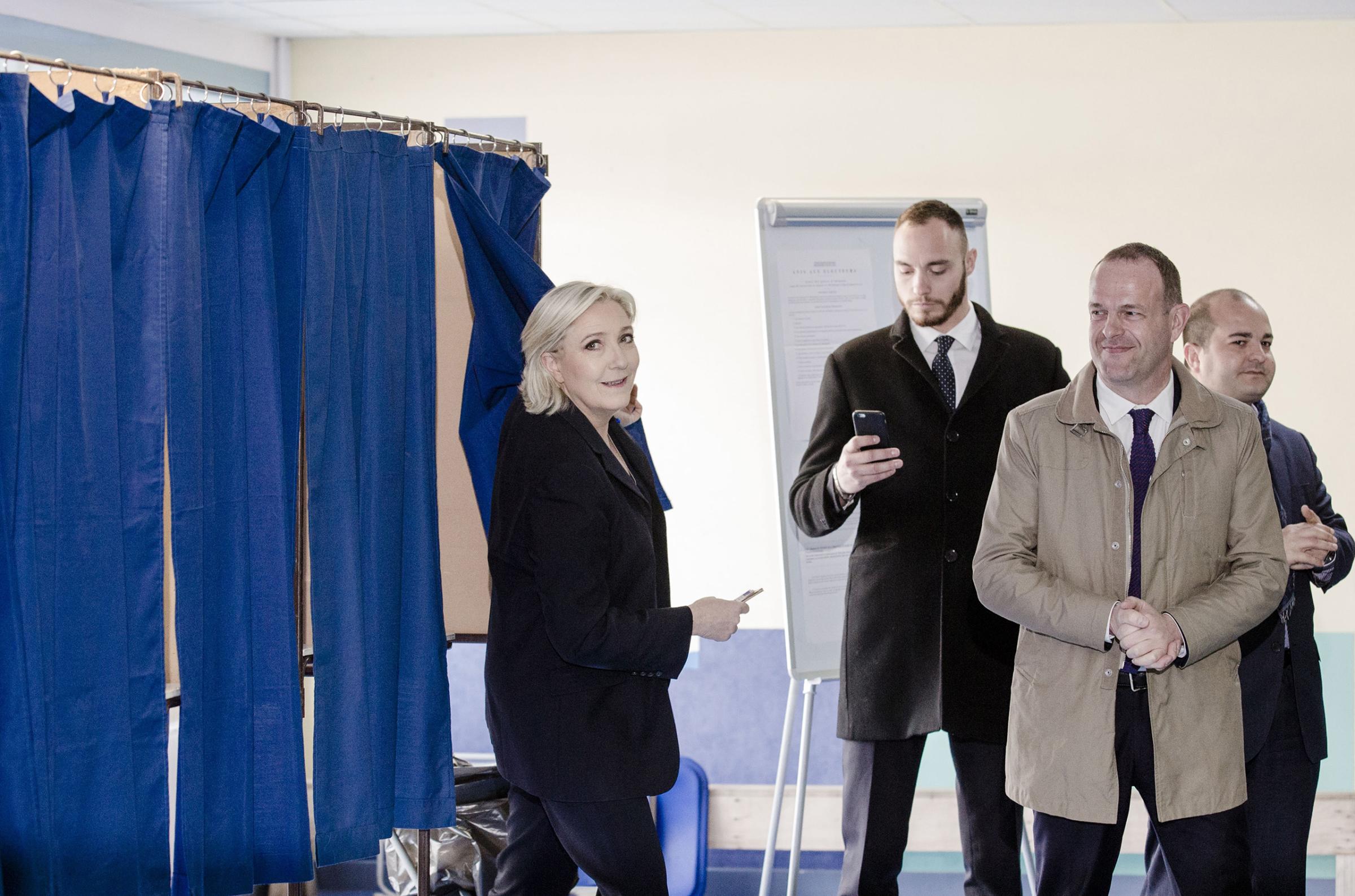 Marine Le Pen, leader of the National Front, exits a polling booth after marking her ballot during the first round of the French presidential election in Henin Beaumont on April 23, 2017.