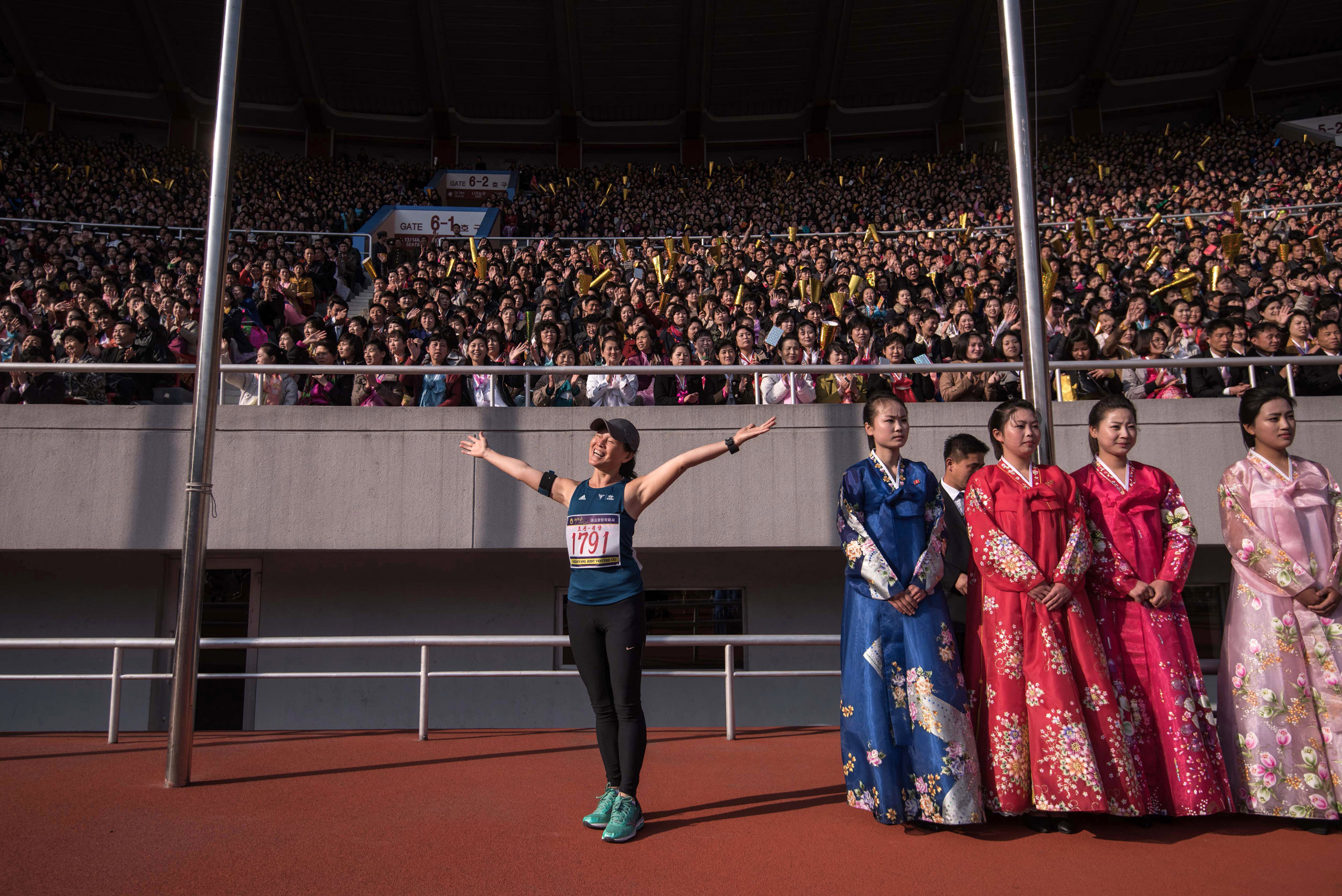 A foreign competitor poses for a photo prior to the start of the Pyongyang Marathon at Kim Il-Sung stadium in Pyongyang on April 9, 2017. Hundreds of foreigners lined up in Pyongyang's Kim Il-Sung Stadium on April 9 for the city's annual marathon, the highlight of the tourism calendar in isolated North Korea. (Ed Jones—AFP/Getty Images)