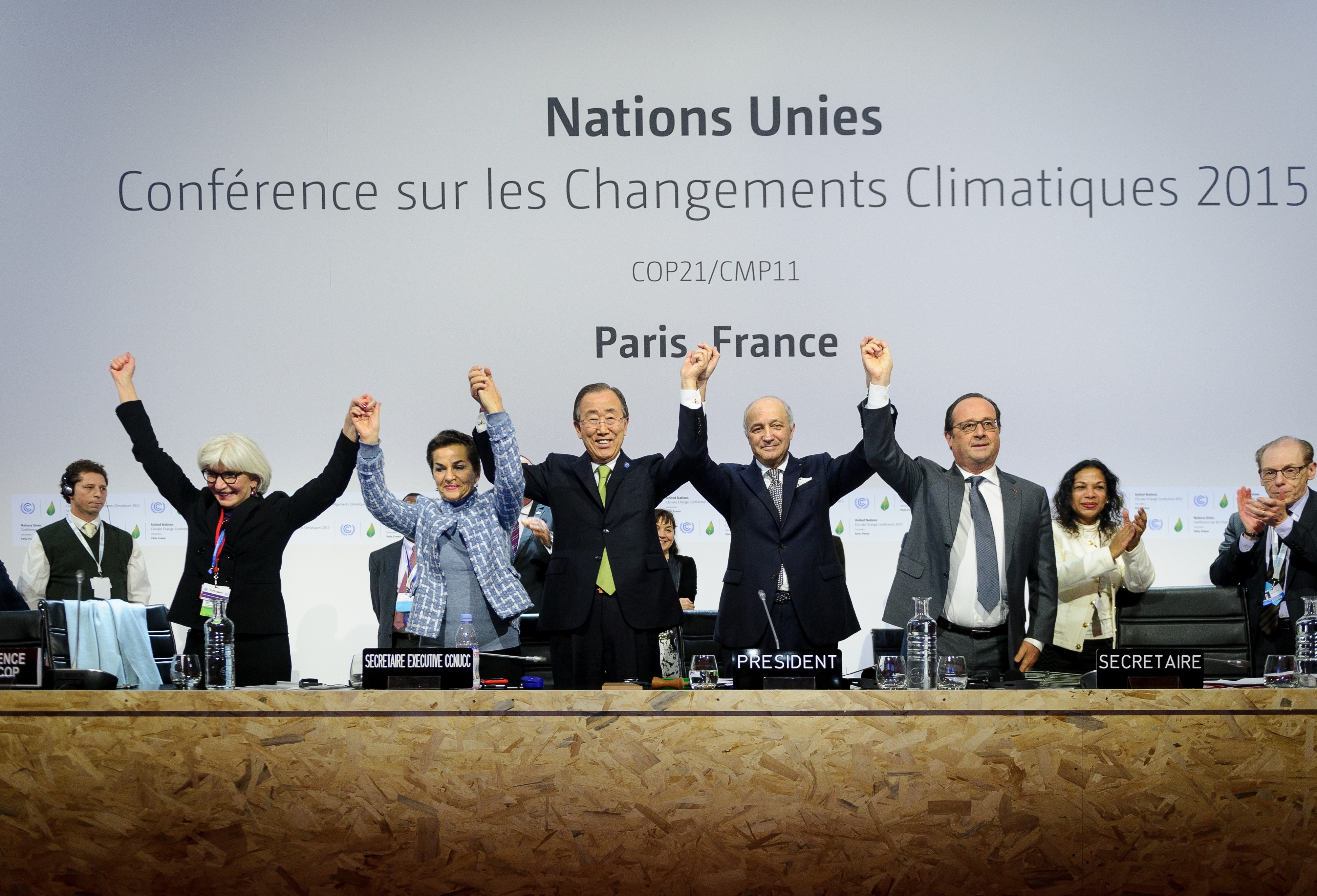 Executive Secretary of the United Nations Framework Convention on Climate Change Christiana Figueres, Secretary General of the United Nations Ban Ki Moon, Foreign Affairs Minister and President-designate of COP21 Laurent Fabius, and France's President Francois Hollande raise hands together after adoption of a historic global warming pact at the COP21 Climate Conference in Le Bourget, north of Paris, on Dec. 12, 2015. (Anadolu Agency—Getty Images)