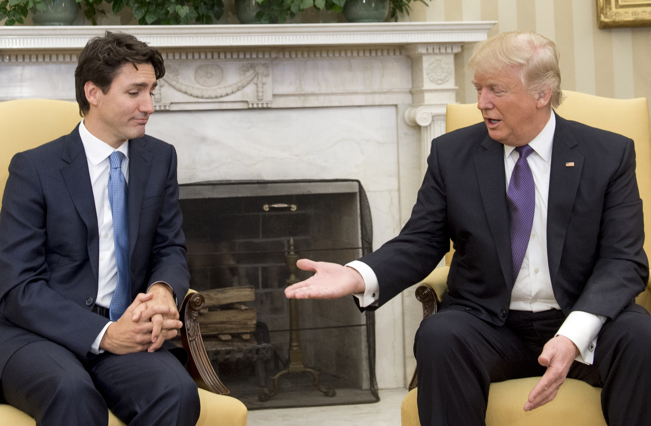 US President Donald Trump and Canadian Prime Minister Justin Trudeau before they shake hands during a meeting in the Oval Office of the White House in Washington, DC, on February 13, 2017.