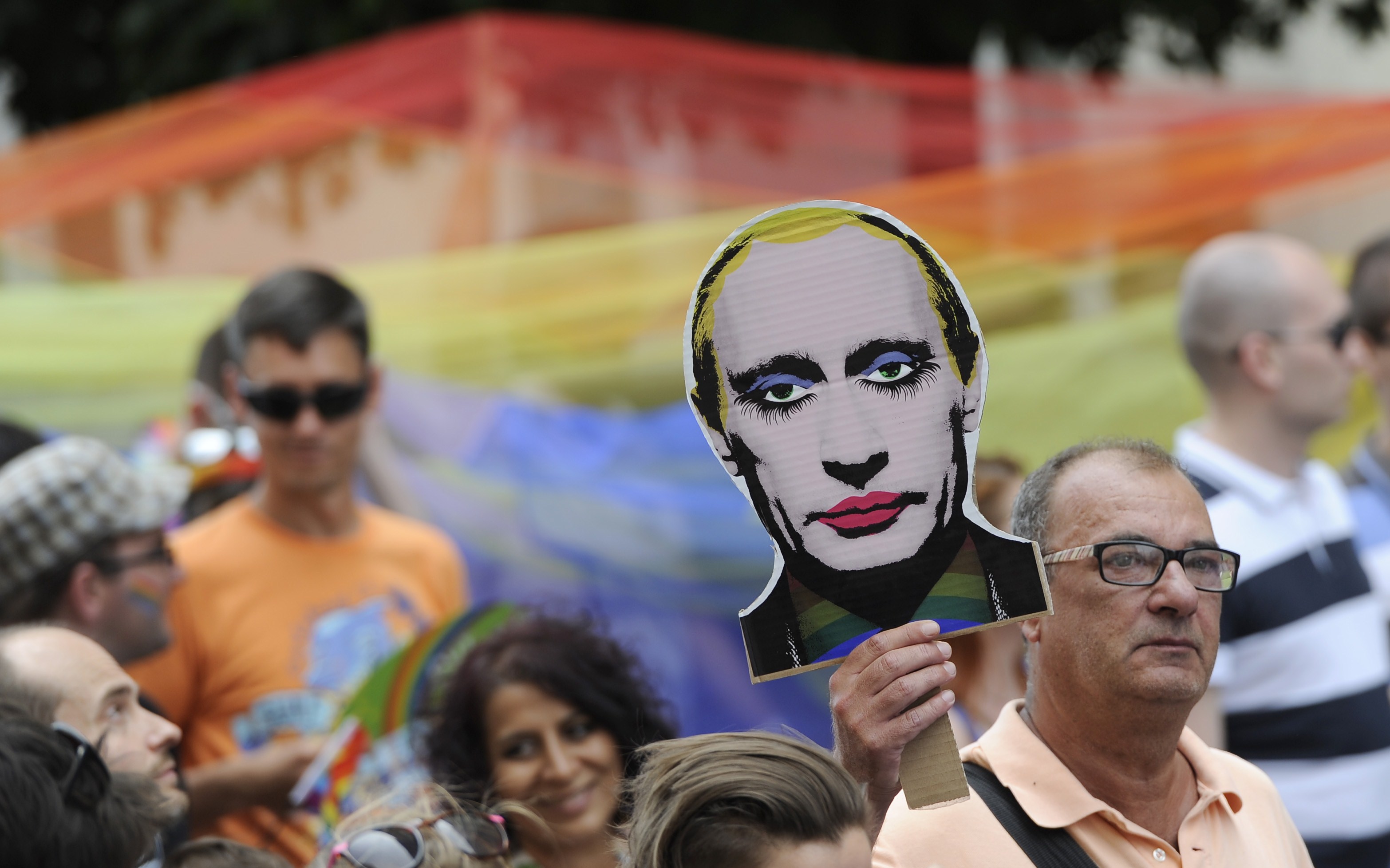 A man holds up a picture of an painted Russian President Vladimir Putin during the LGBT Pride Parade in Bratislava, Slovakia on June 28, 2014. (Samuel Kubani—AFP/Getty Images)