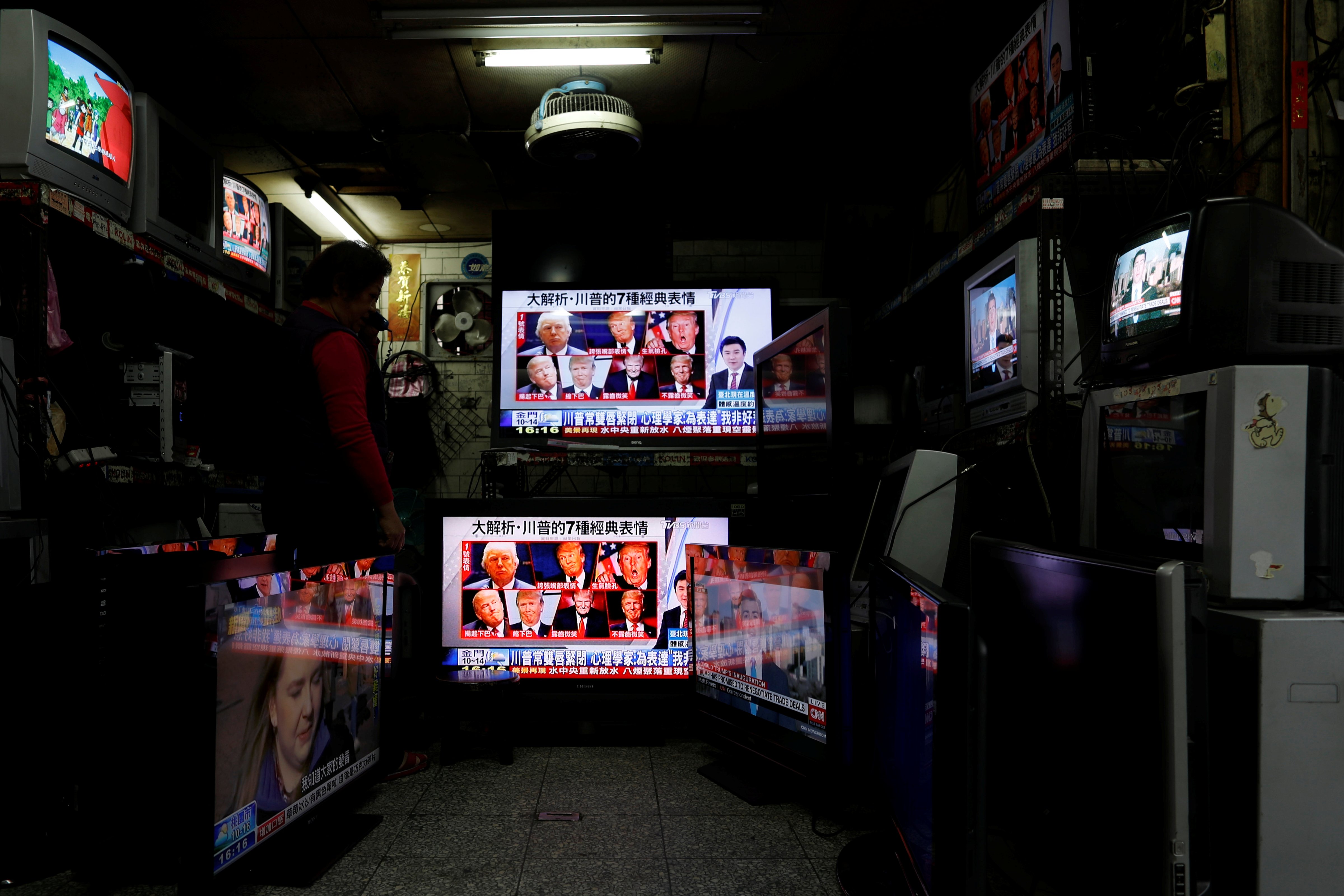 Images of U.S. President Donald Trump are seen on TV screens at a second hand shop in Taipei,Taiwan