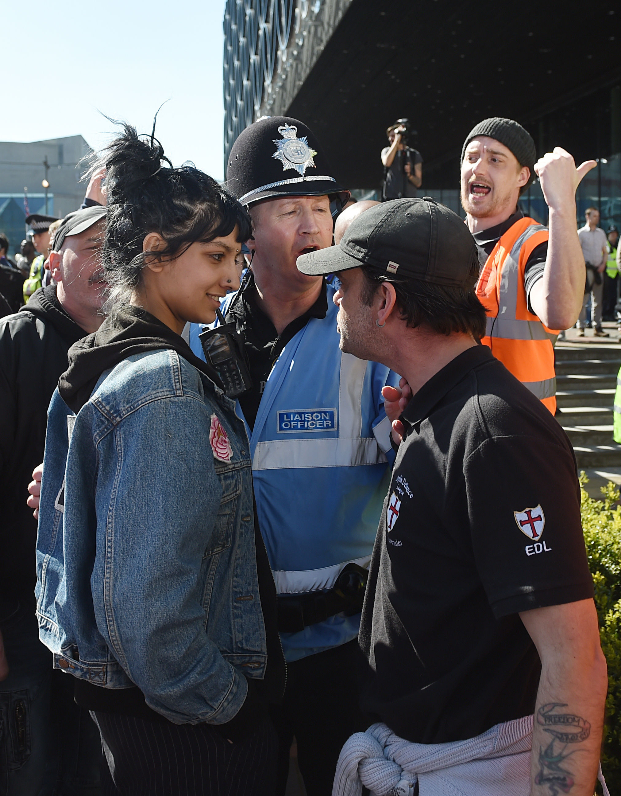 Saffiyah Khan, left, stars down English Defence League protester Ian Crossland during a demonstration in Birmingham, England, on April 10, 2017. (Joe Giddens—PA Wire/AP)