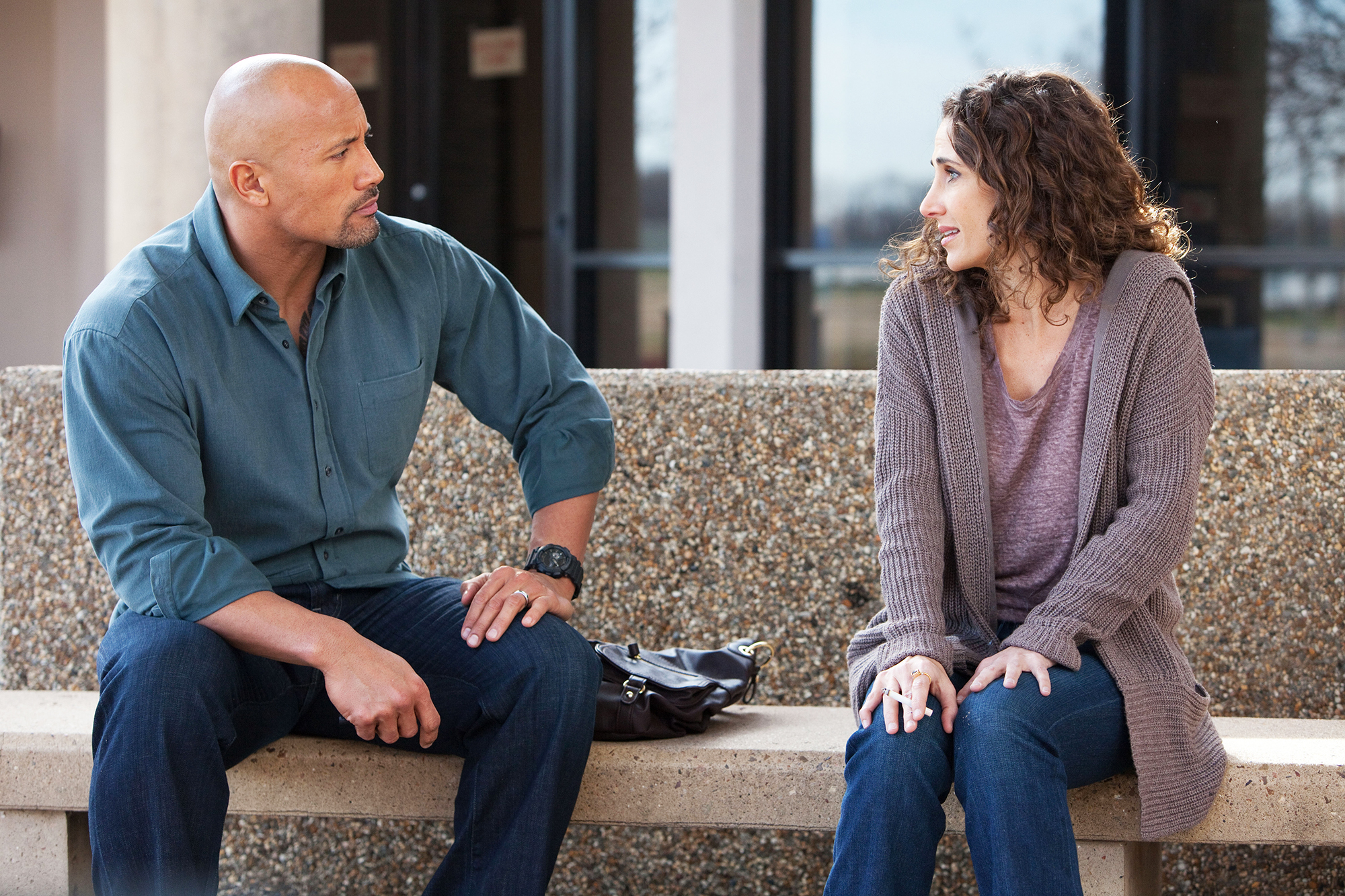 Dwayne Johnson, as John Matthews, and Melina Kanakaredes, as Sylvie Collins, in Snitch in 2013.