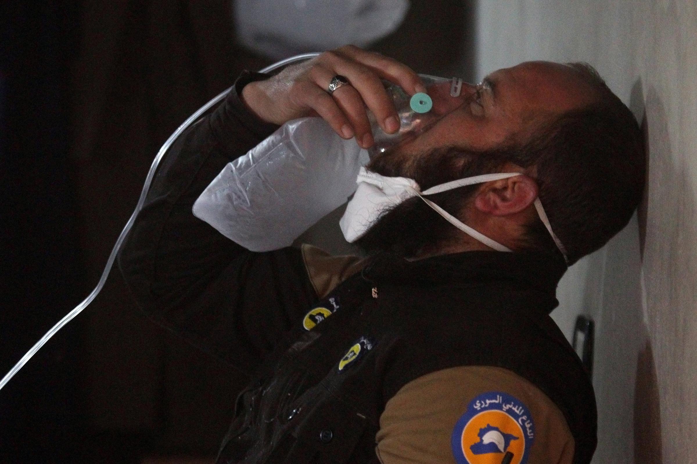 A civil defence member breathes through an oxygen mask after what rescue workers described as a suspected gas attack in the town of Khan Sheikhoun, in rebel-held Idlib, Syria, on April 4, 2017.