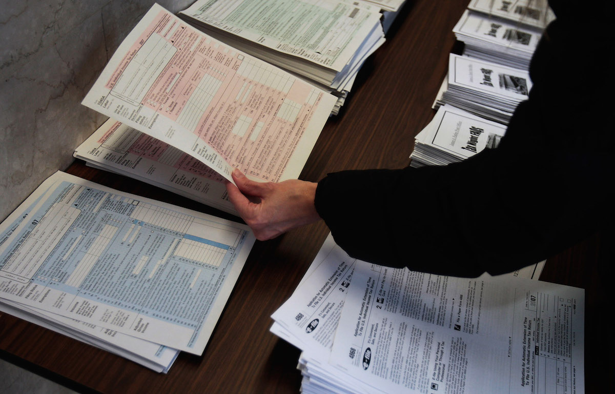 A woman picks up tax forms in the lobby of the Farley Post Office on April 15, 2008, in New York City. (Chris Hondros—Getty Images)