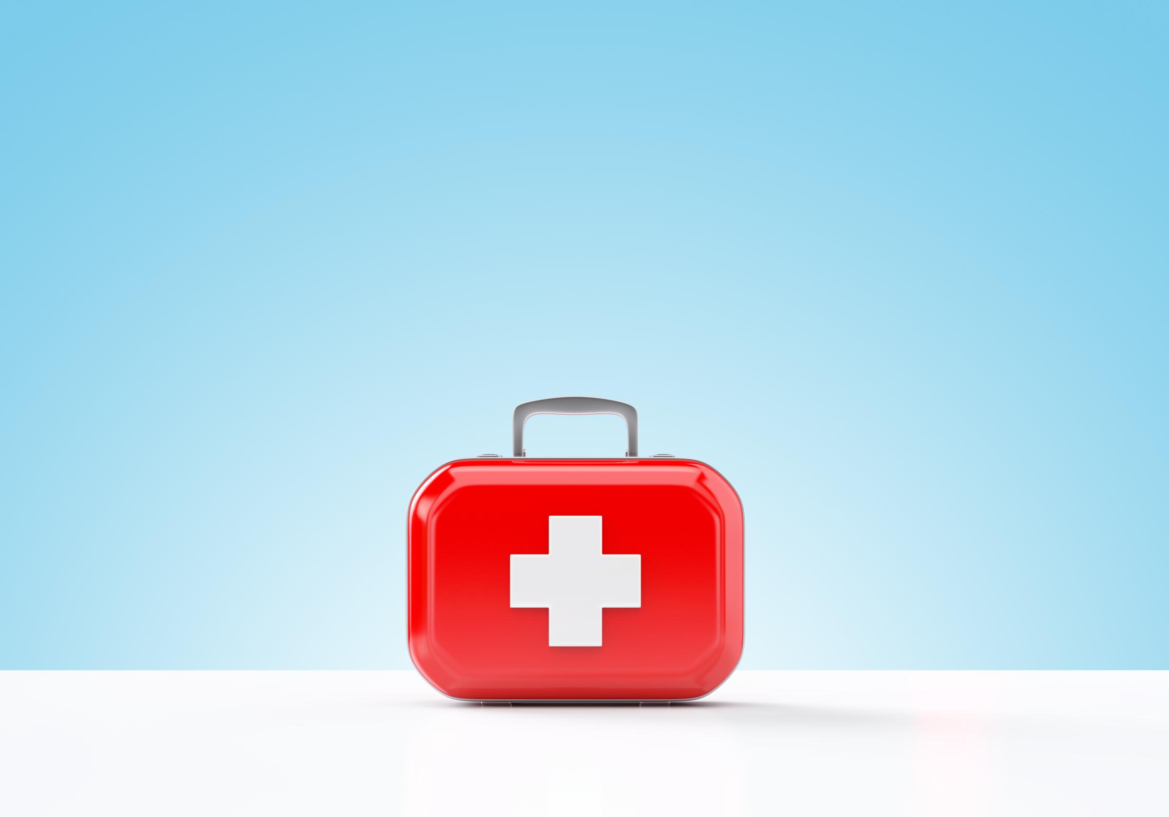 First aid kit standing on a blue and white background TIME health stock