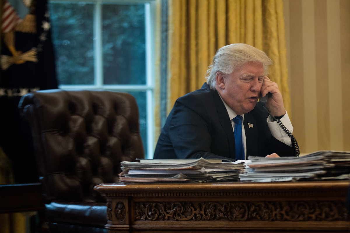 President Donald Trump speaks on the phone with Chancellor of Germany Angela Merkel in the Oval Office of the White House, Jan. 28, 2017 in Washington, D.C. (Drew Angerer—Getty Images)