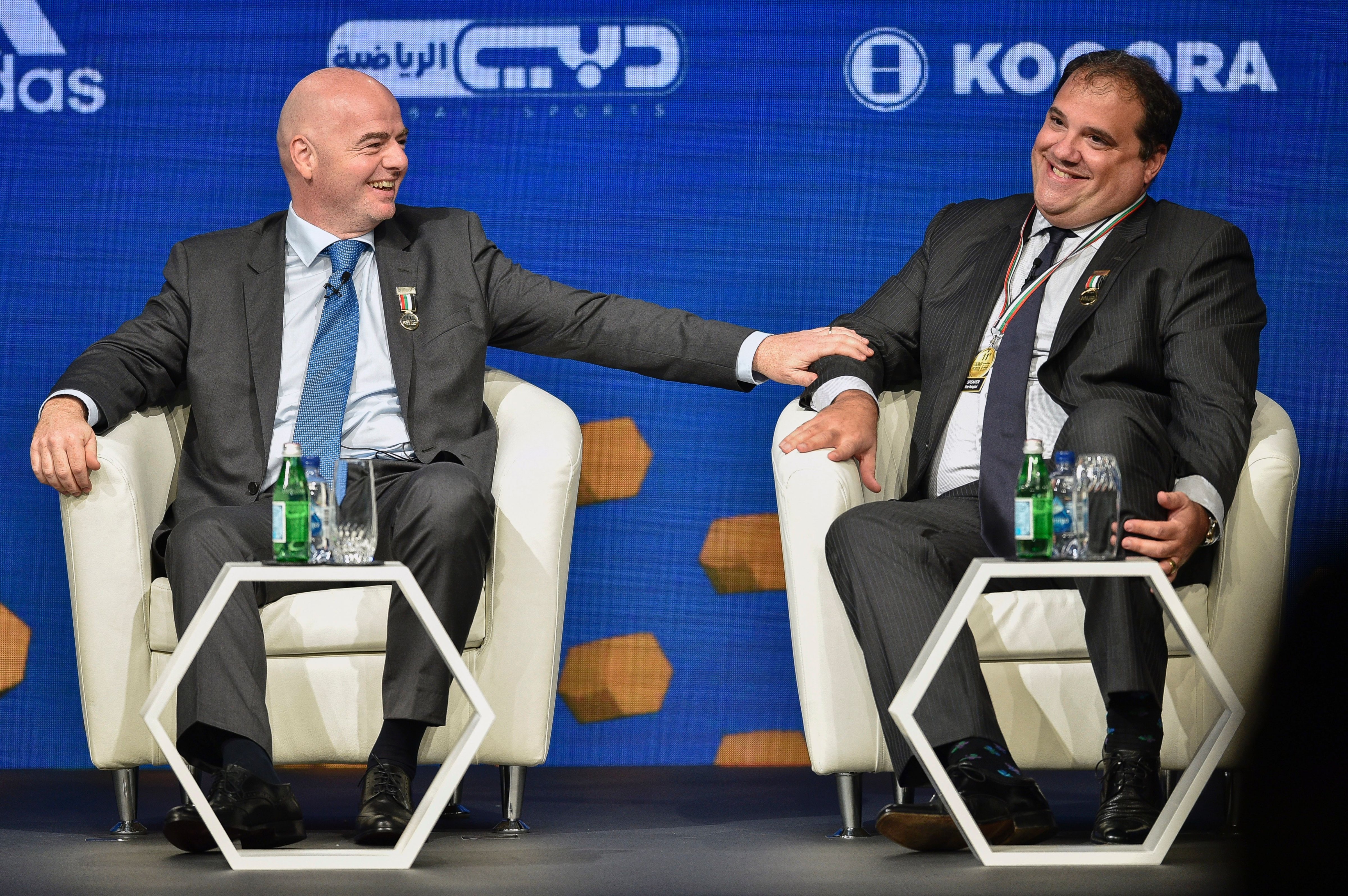 FIFA President, Gianni Infantino (L), talks with Victor Montagliani, CONCACAF President, during the Dubai international Sports conference at Madinat Jumeirah in Dubai on December 28, 2016. (Stringer—AFP/Getty Images)
