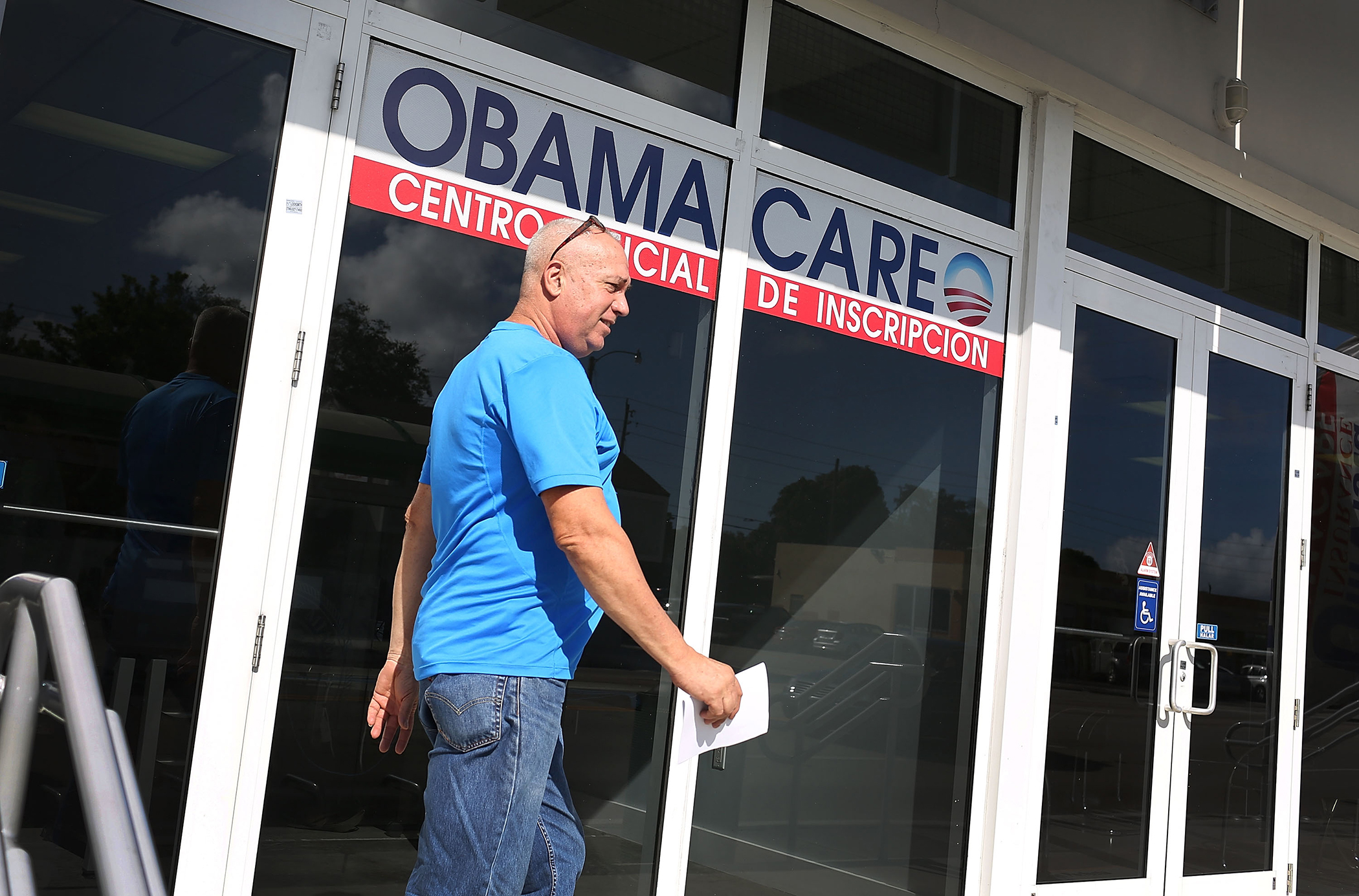 Alberto Abin walks out of the UniVista Insurance company office after shopping for a health plan under the Affordable Care Act, also known as Obamacare, on December 15, 2015 in Miami, Florida. (Joe Raedle—Getty Images)