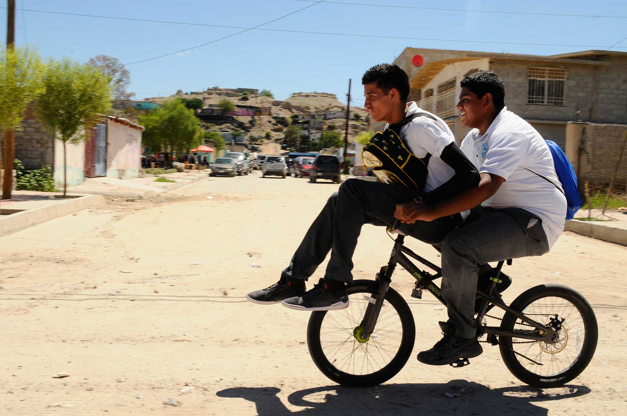 Students return from school on their bike in Juarez.