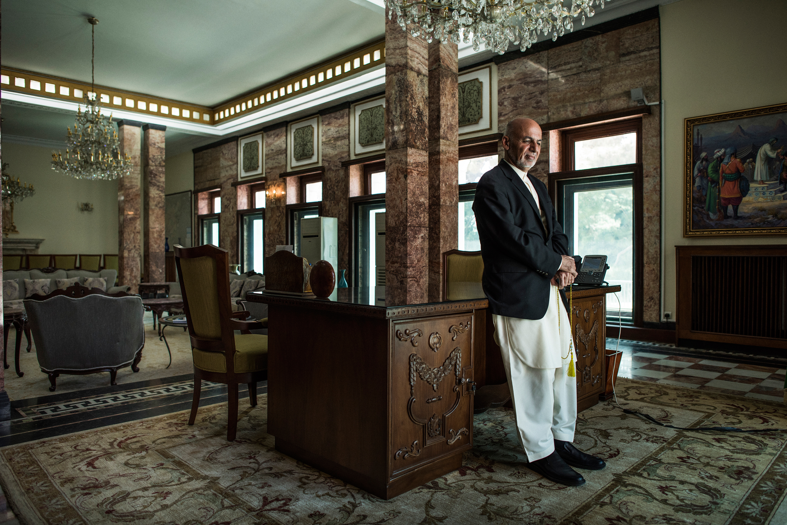 Afghan President Ashraf Ghani stands at his desk in the presidential palace in Kabul on May 11, 2017. (Andrew Quilty for TIME)