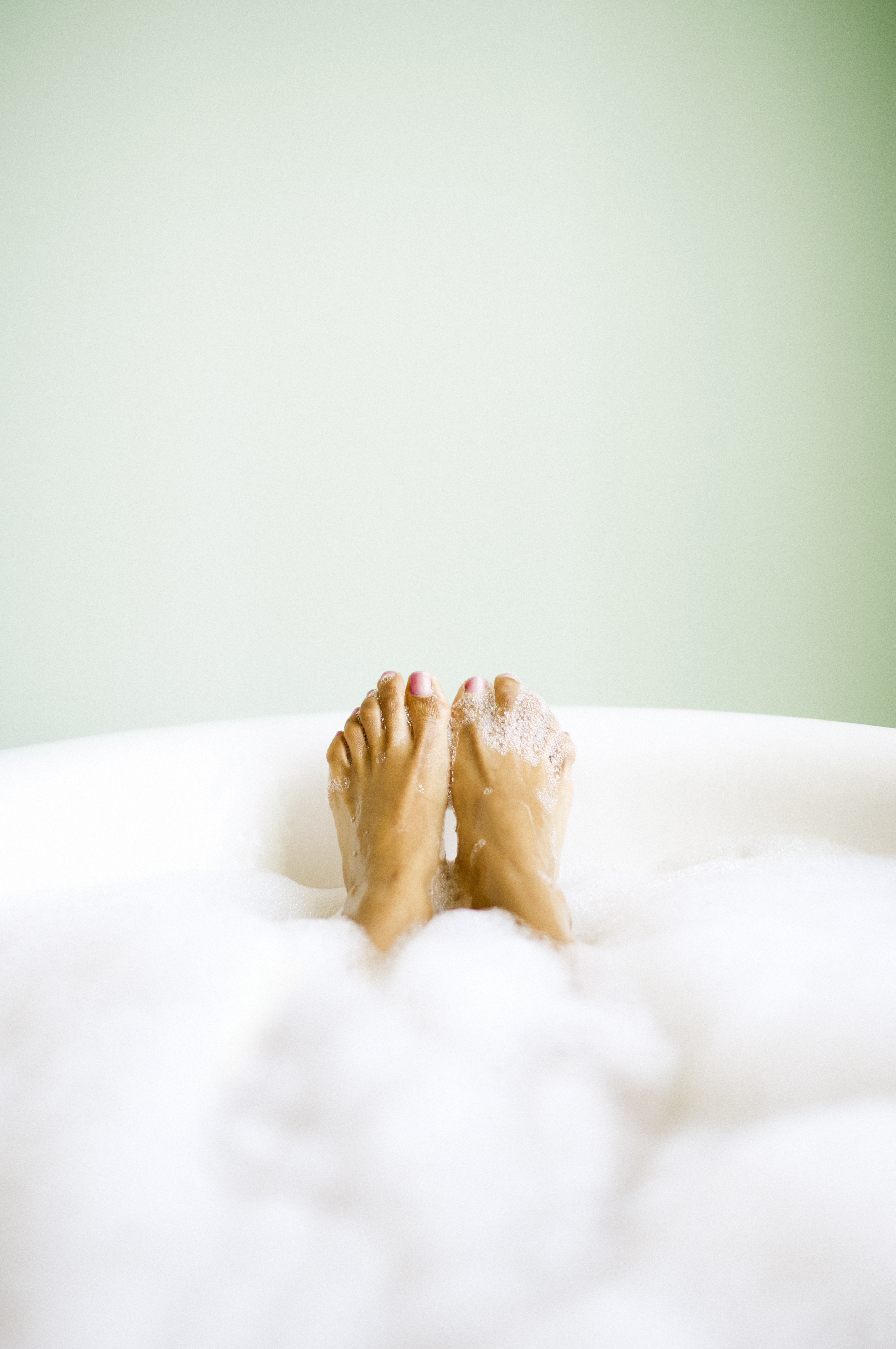 Woman's Feet Emerging in Bubble Bath