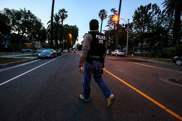 An ICE Enforcement and Removal Operations agent, on his way to raid and apprehend an immigrant without legal status in Riverside, Calif. on Aug.
                       12, 2015. (Irfan Khan—LA Times/Getty Images)