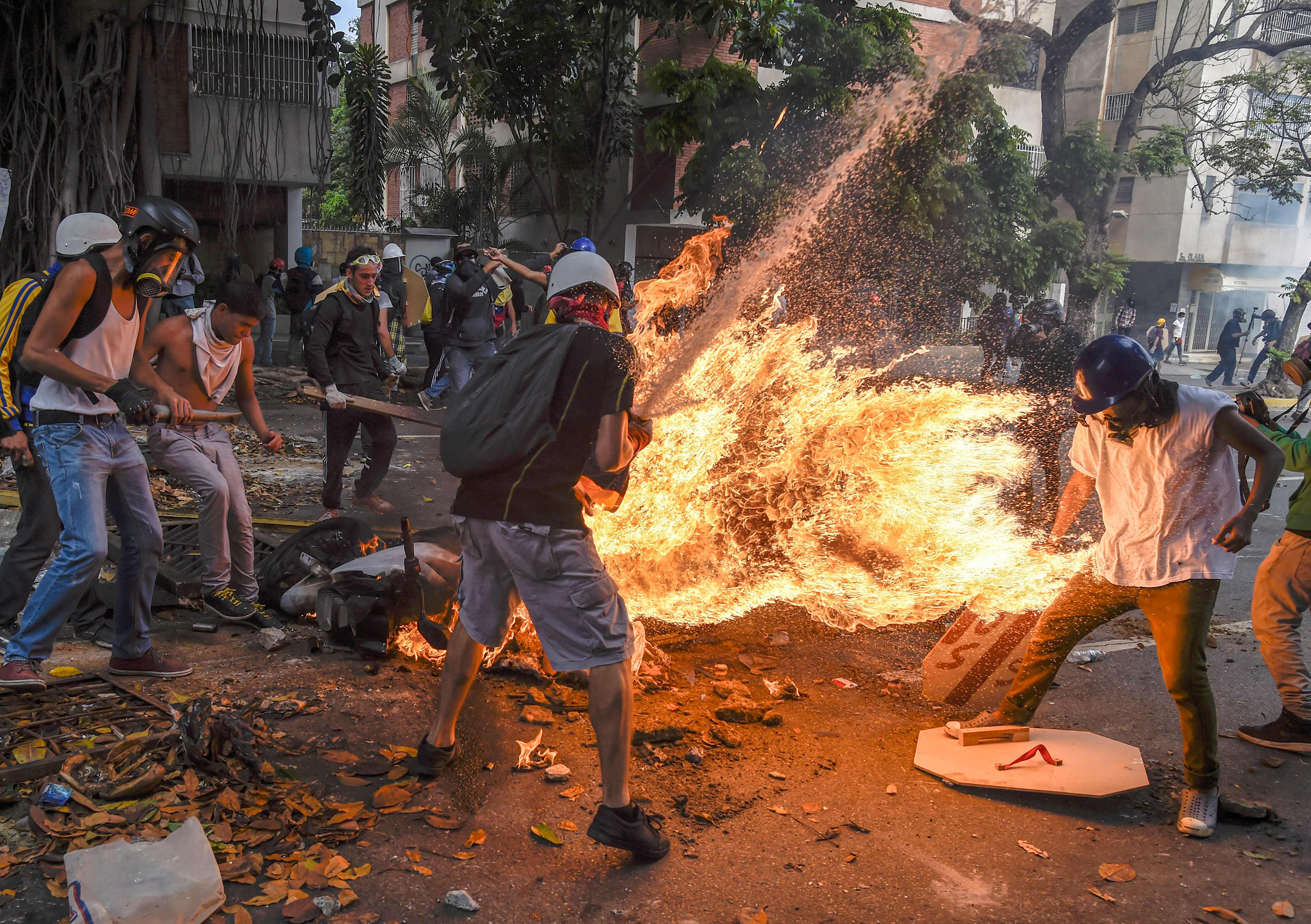 The gas tank of a police motorbike explodes during a protest in Caracas on May 3, 2017.
