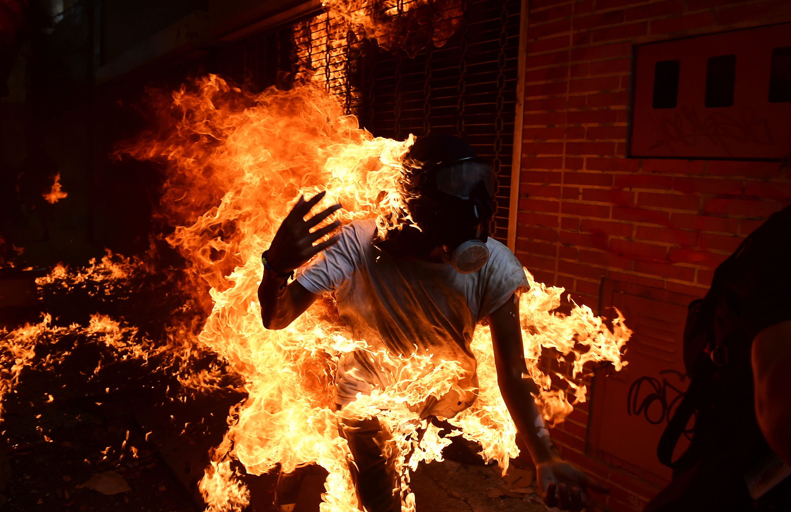 A man set ablaze runs during an anti-Maduro protest in Caracas on May 3, 2017.