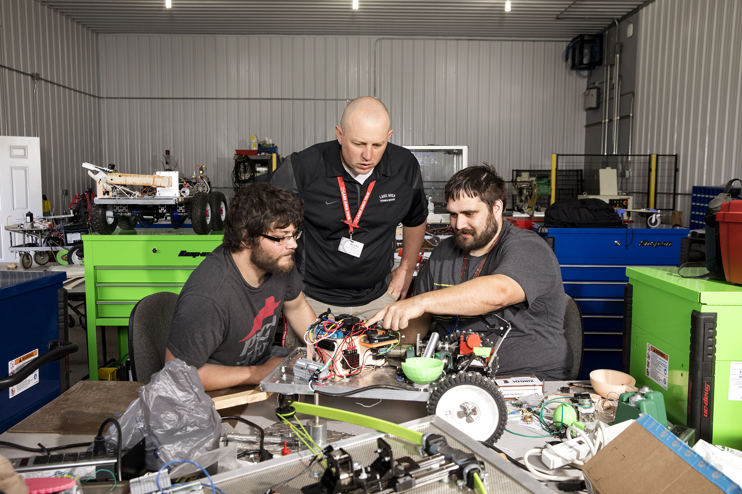 LATI instructor Brooks Jacobsen works with students in the school’s robotics lab (Ackerman + Gruber for TIME)