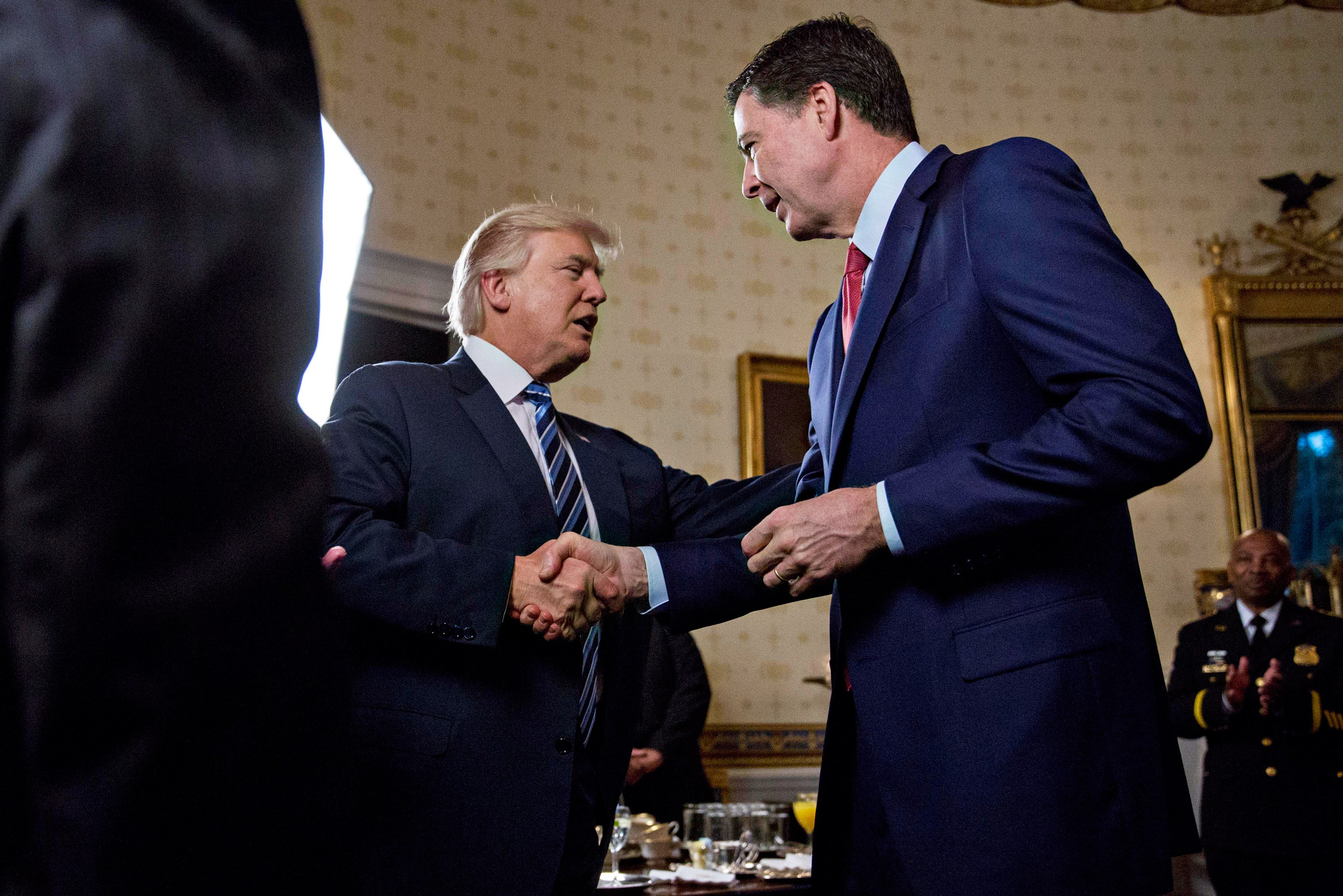 President Trump shook hands with Comey during an Inaugural reception at the White House in January (Andrew Harrer—Picture-Alliance/DPA/AP)