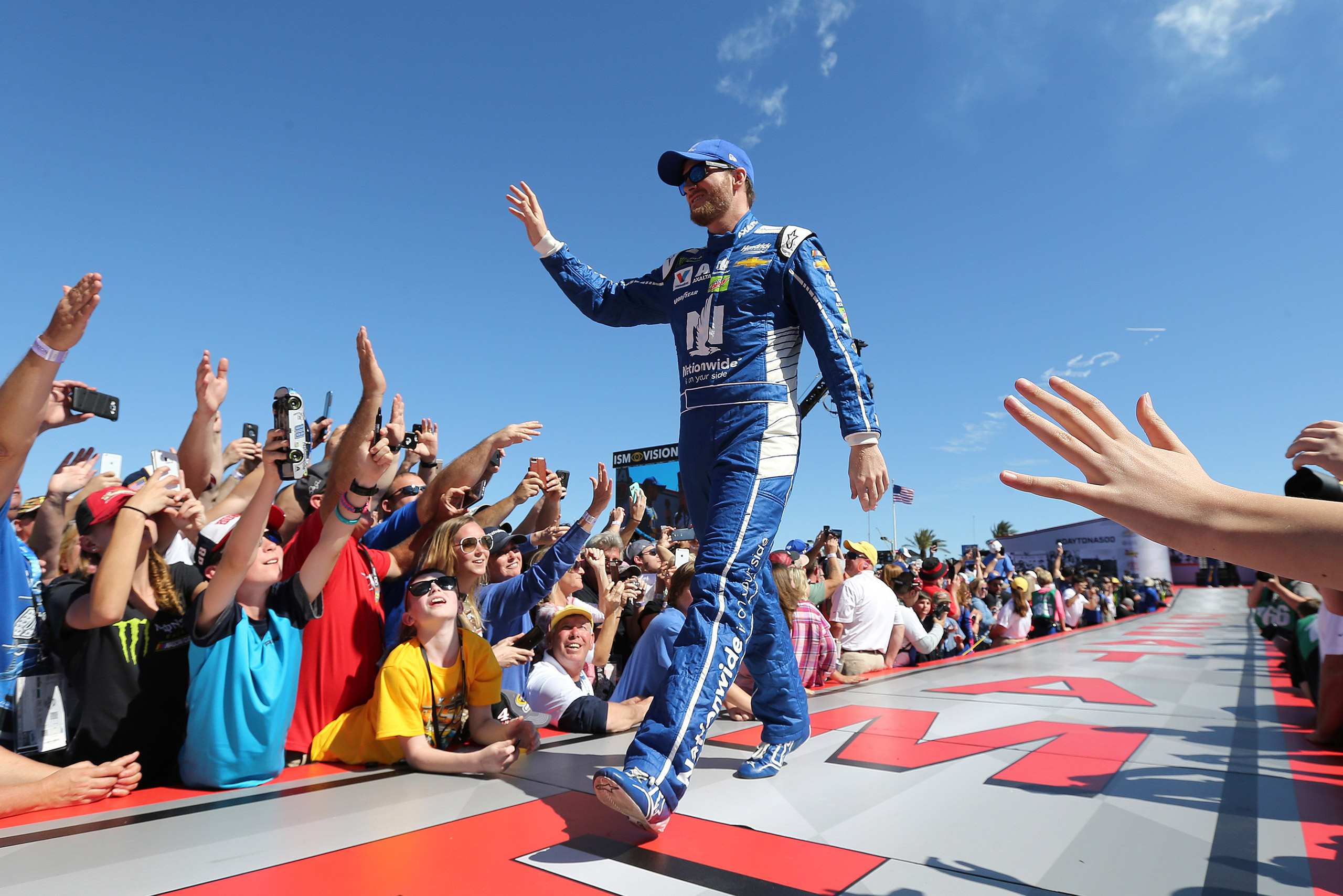 NASCAR driver Dale Earnhardt Jr. waves to the crowd during driver introductions prior to the start of the 59th Annual NASCAR Daytona 500 auto race at Daytona International Speedway on February 26, 2017 in Daytona Beach, Florida. (Alex Menendez&mdash;AP)