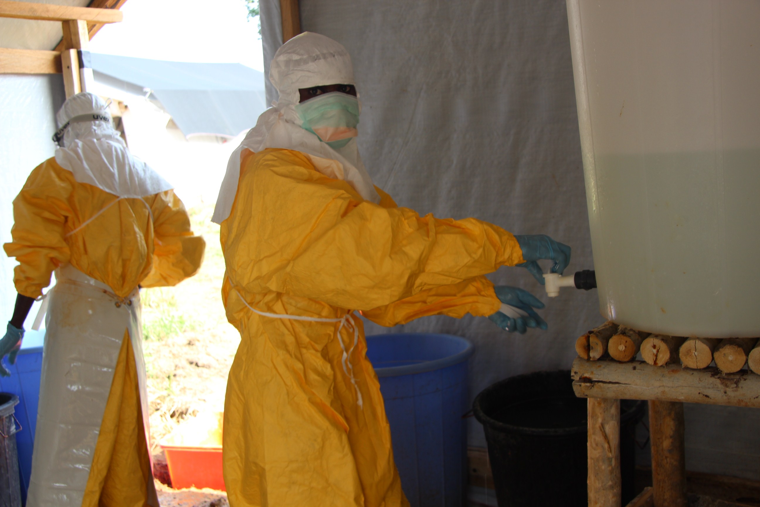 Hygienists wearing protective suits disinfect the toilets of the Ebola treatment centre in Lokolia, on October 5, 2014.