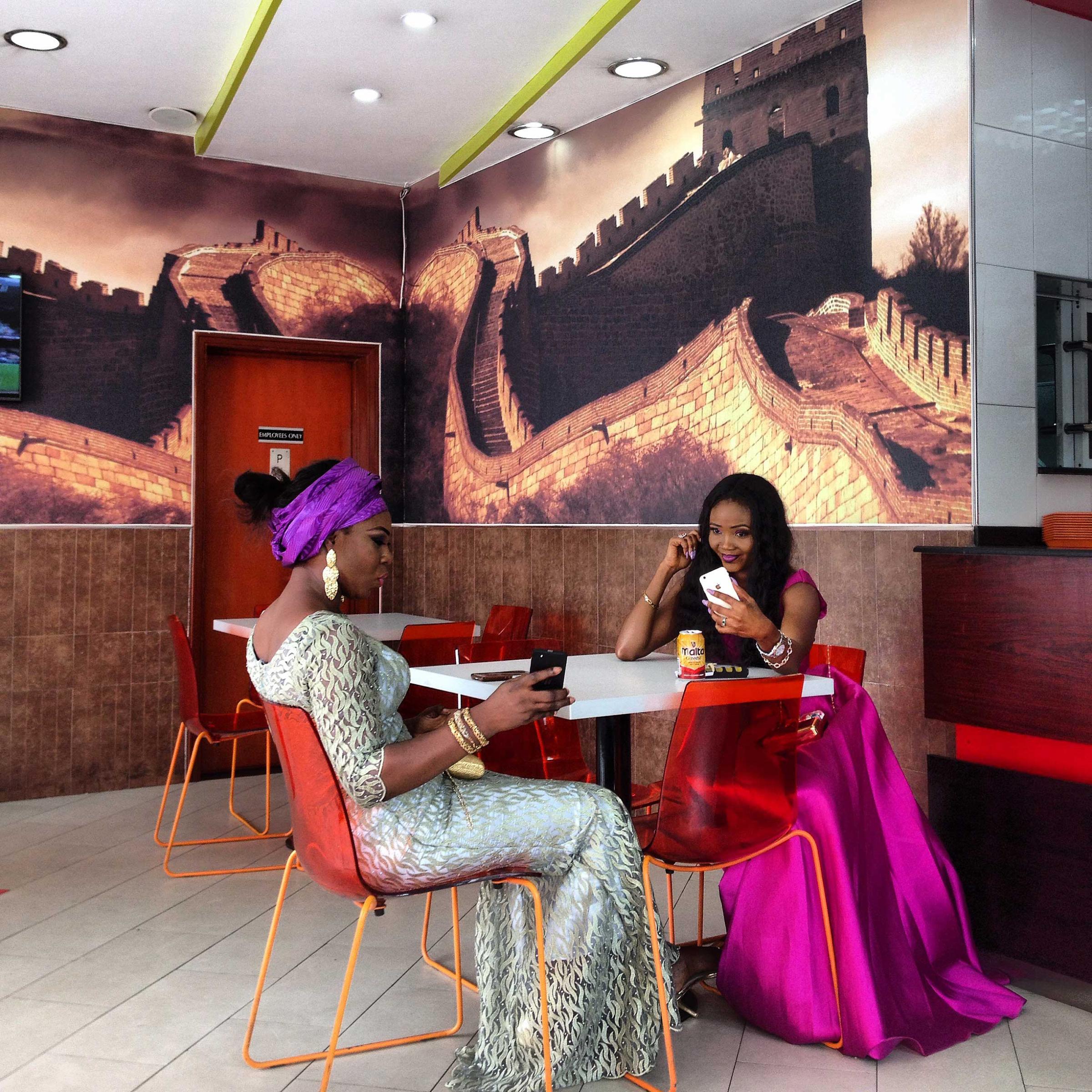 Two women and their cell phones in Lagos, Nigeria. @andrewesiebo