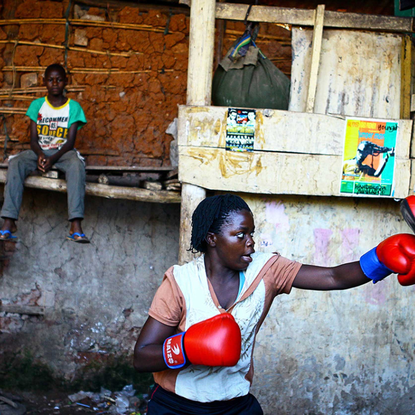 A female boxer trains inside a makeshift gym in Katanga, Kampala, Uganda. @edward_echwalu