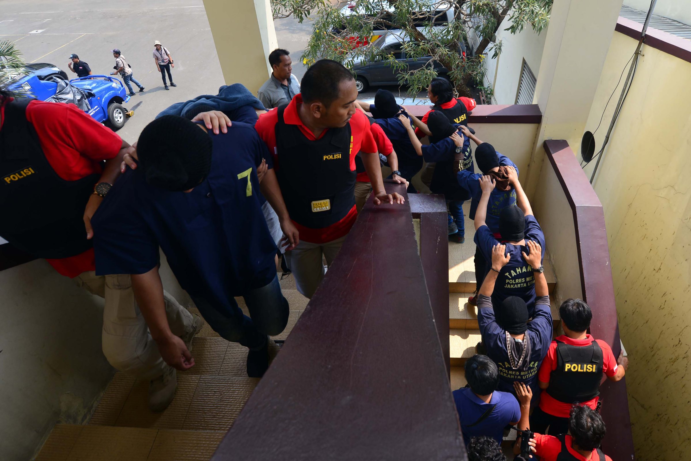 Indonesian police guard men arrested in a recent raid during a press conference at a police station in Jakarta on May 22, 2017.