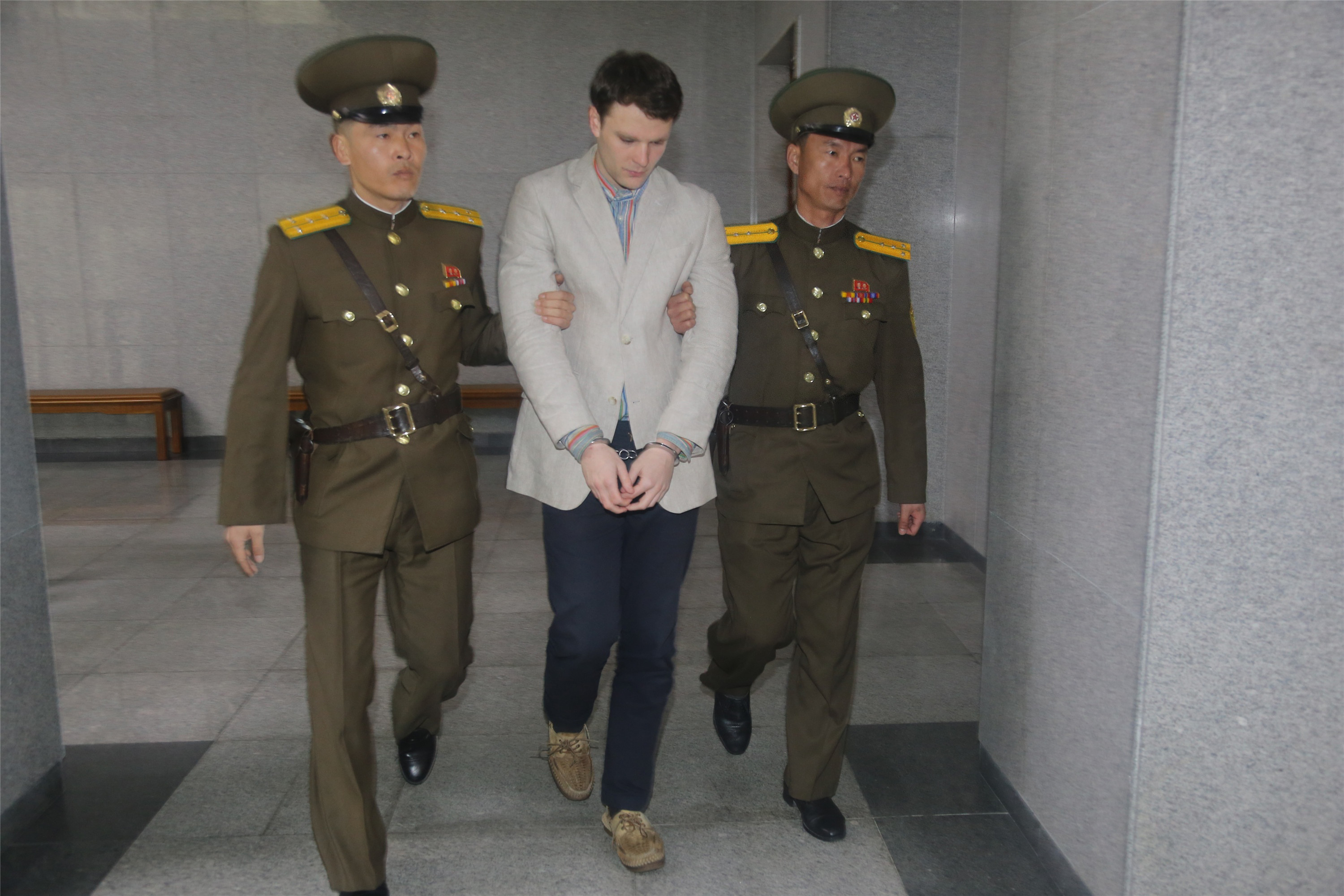 American student Otto Frederick Warmbier, center, arrives at a court for his trial in Pyongyang on March 16, 2016. (Lu Rui—Xinhua News Agency/Getty Images)