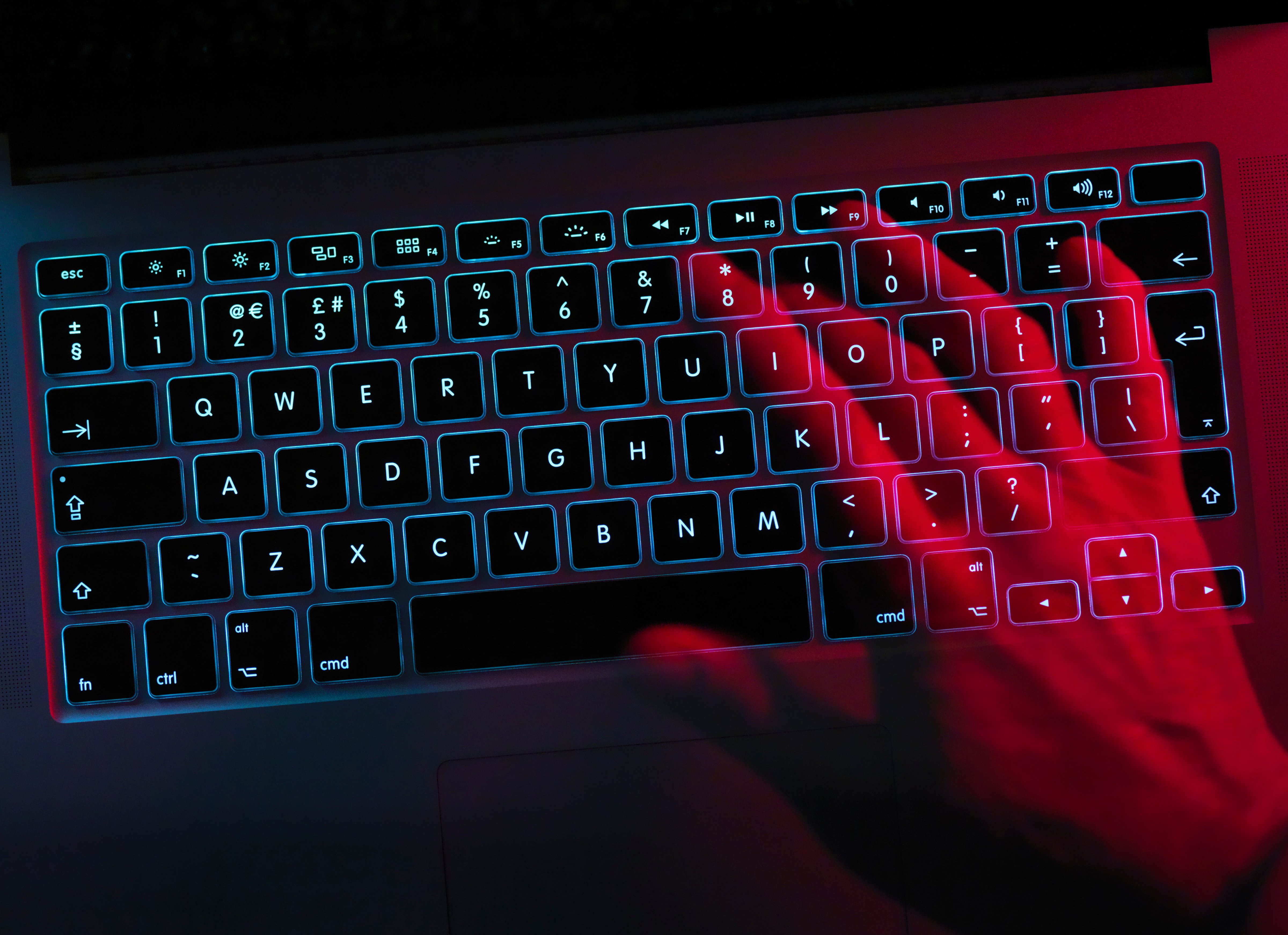 Hand working at laptop computer illustrating cyber crime