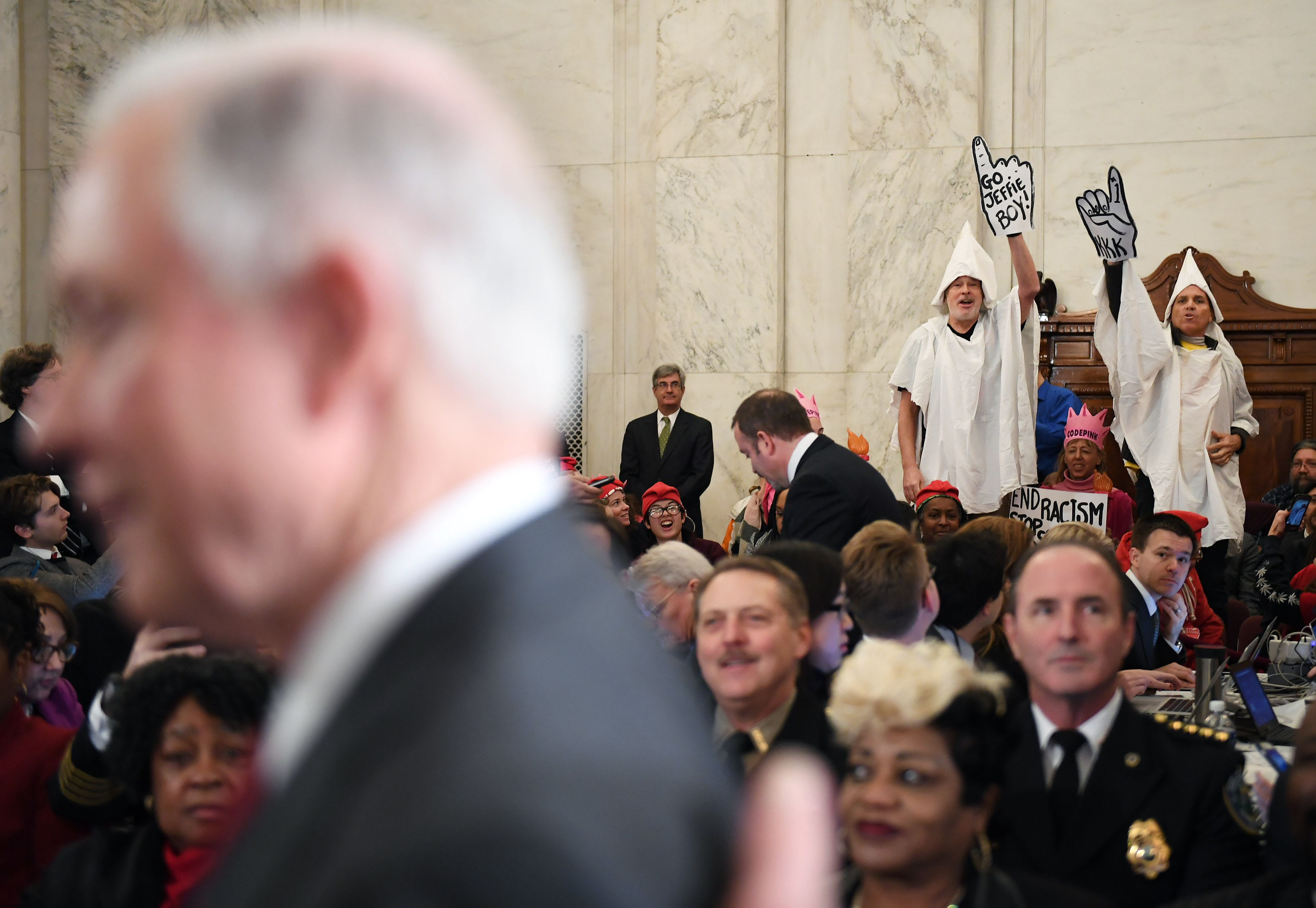 Senator Jeff Sessions (R-AL) is seen before his Attorney General confirmation hearing as Code Pink demonstrators dressed as KKK members stand up and call to the Senator at the Russell Senate Office Building on Tuesday January 10, 2017 in Washington, DC. (Photograph by Matt McClain—Getty/The Washington Post)