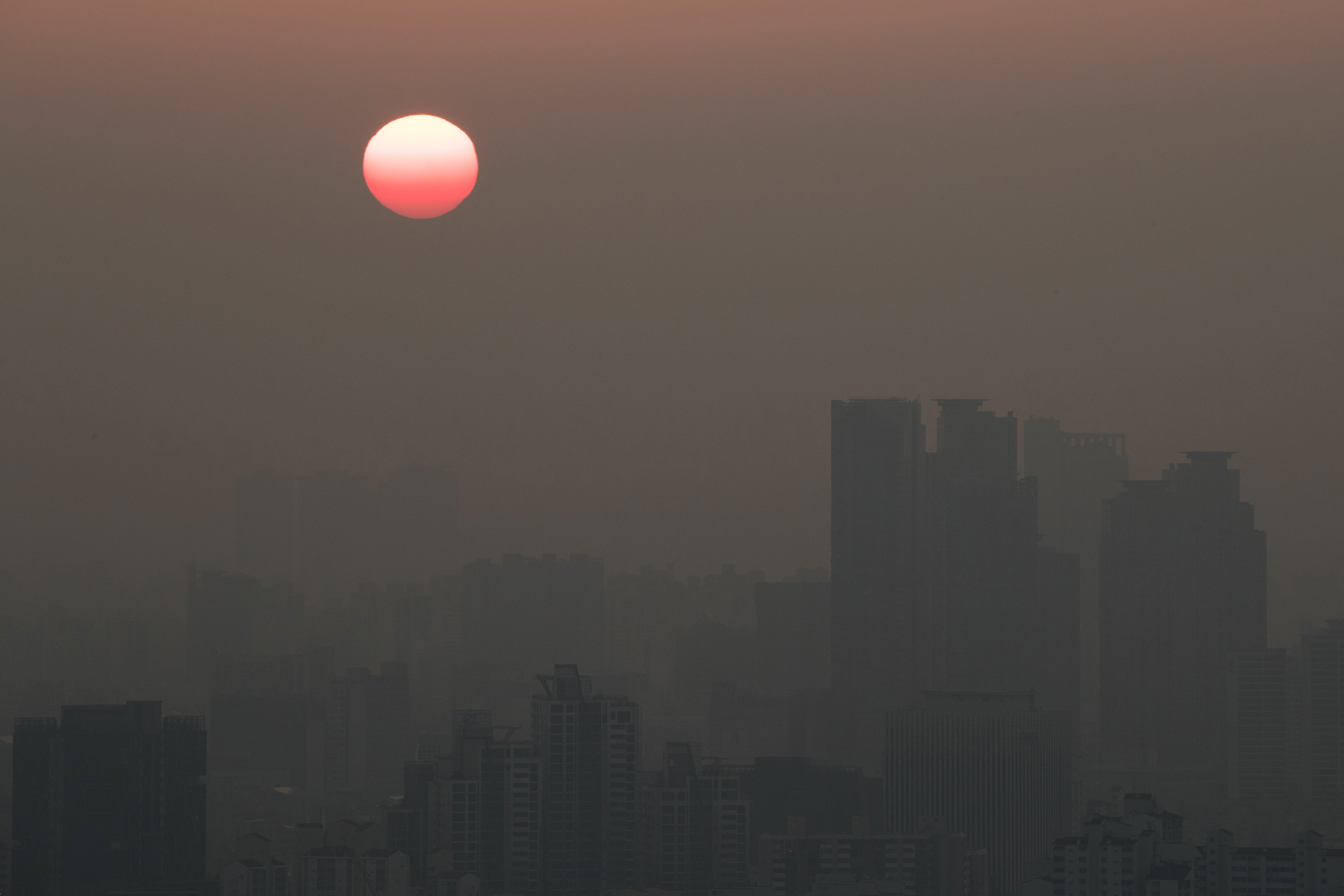 The sun rises over residential and commercial buildings in Seoul, South Korea, on Monday, March 13, 2017. (SeongJoon Cho/Bloomberg via Getty Images)